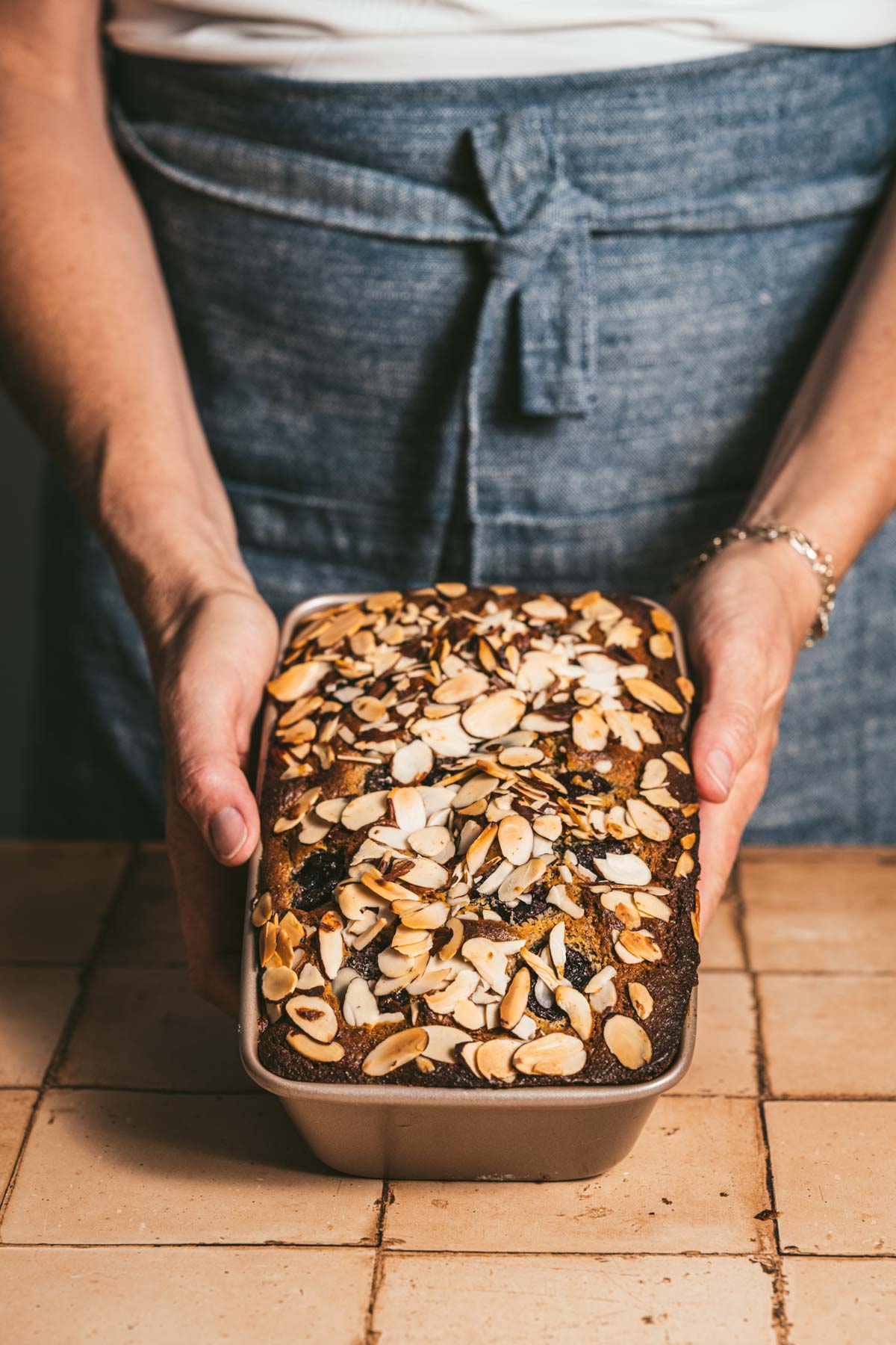 hands in frame holding baked bread