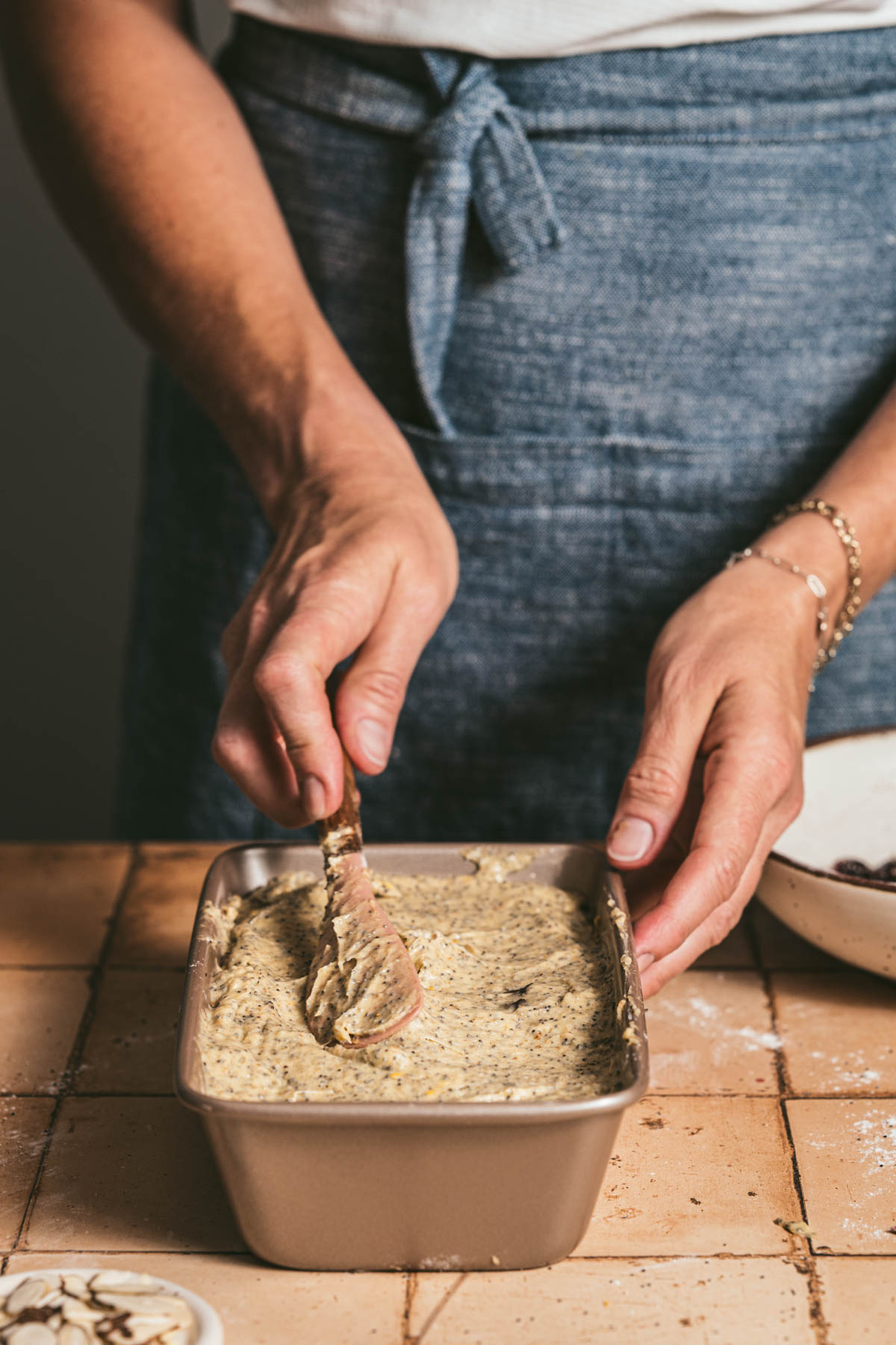 hands in frame smothing the top of the batter