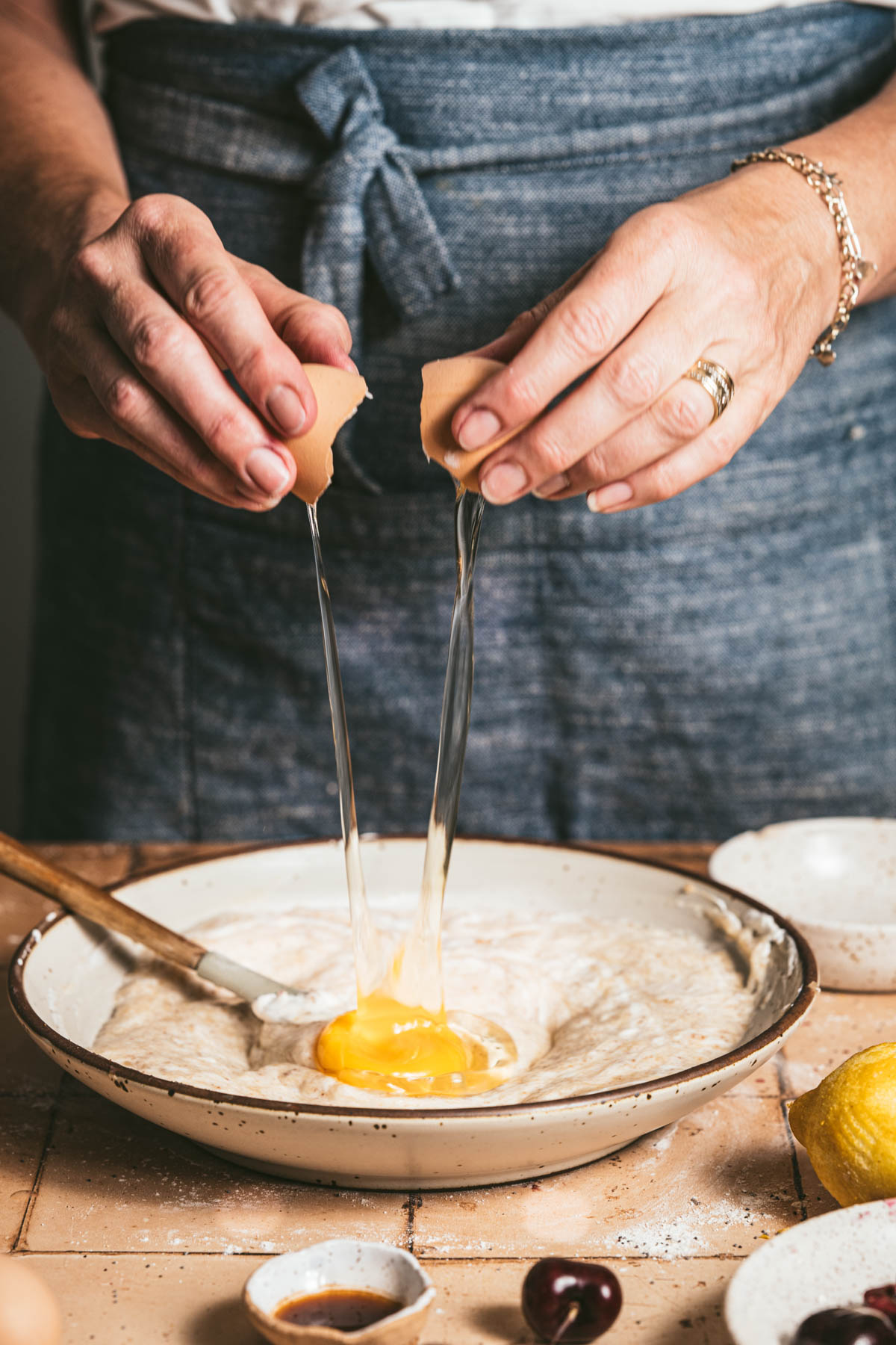 hands in frame cracking an egg