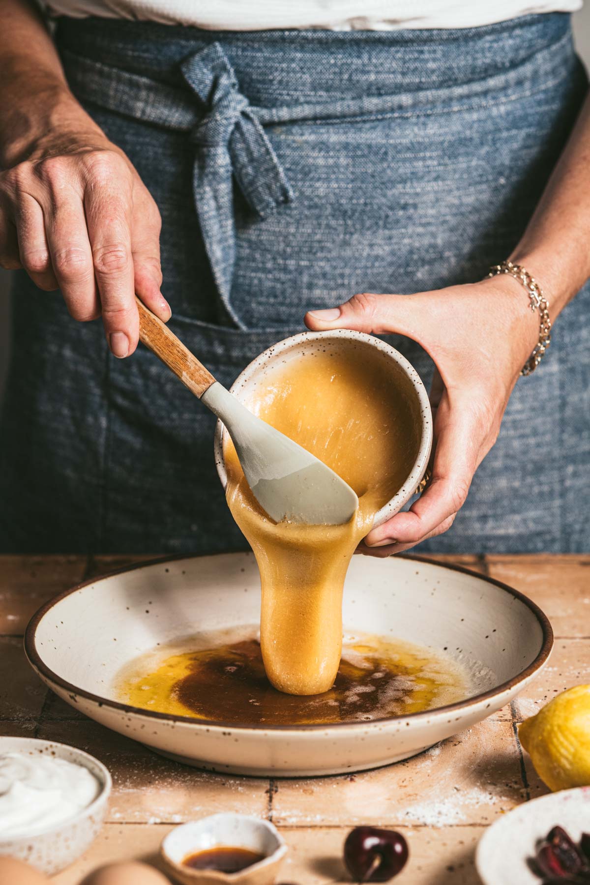 hands in frame adding honey