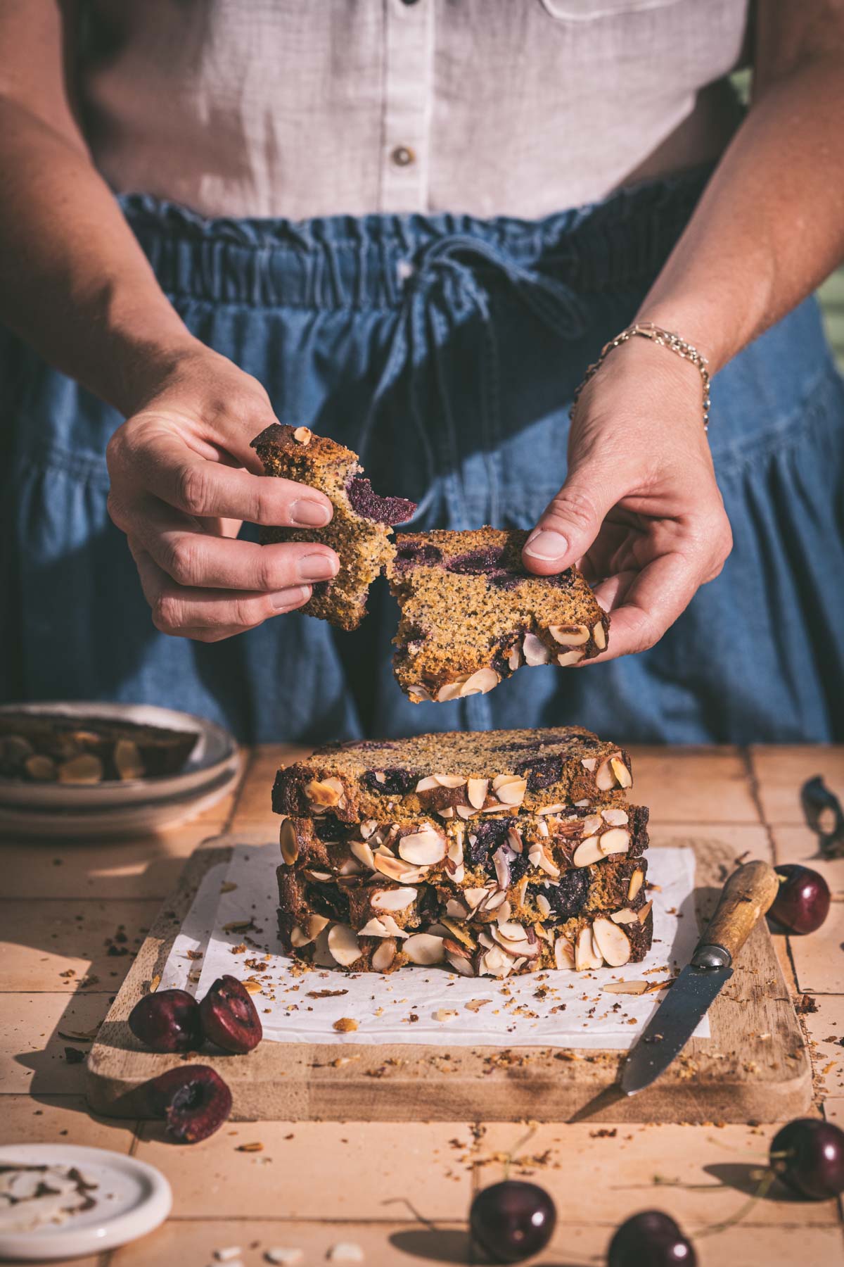 hands in frame tearing a slice