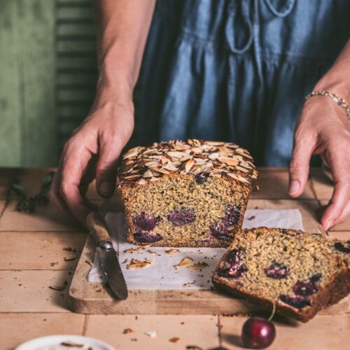 hands in frame holding cherrey bread