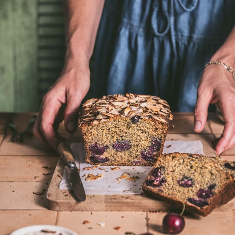 hands in frame holding cherrey bread