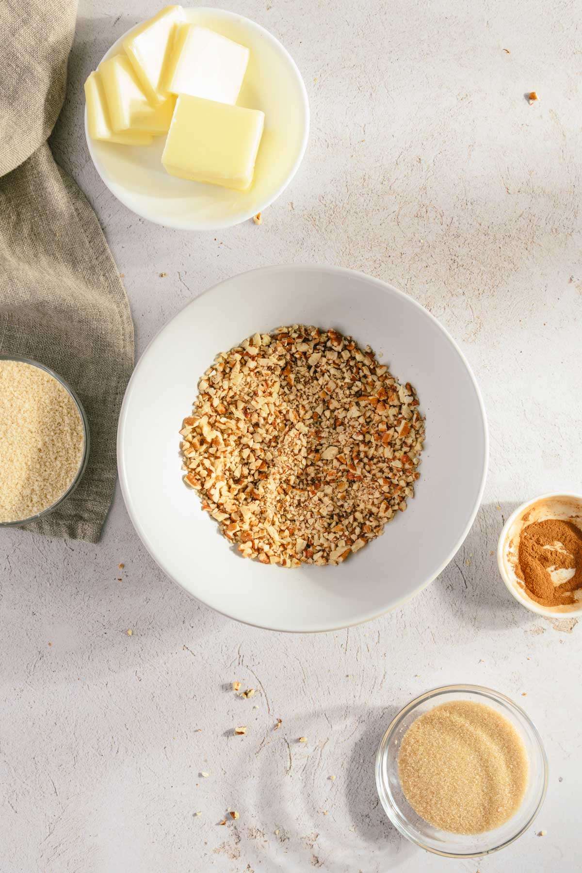 ingredients to make the crumble, medium size bowl in the center with chopped pecans