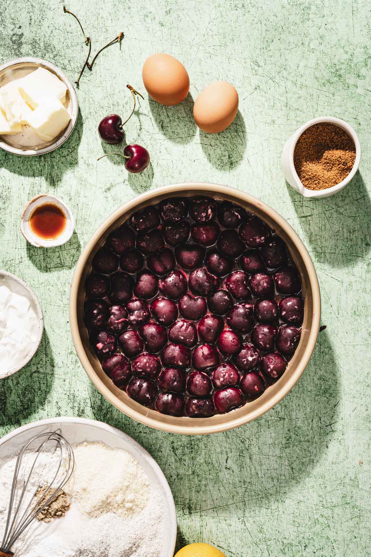 cake pan with cherries arranged on the bottom