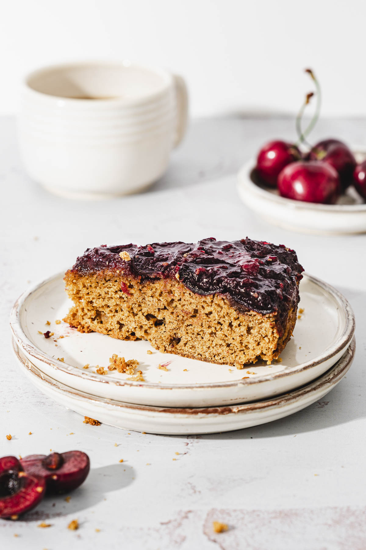 slice of cake on a plate, cup of coffee