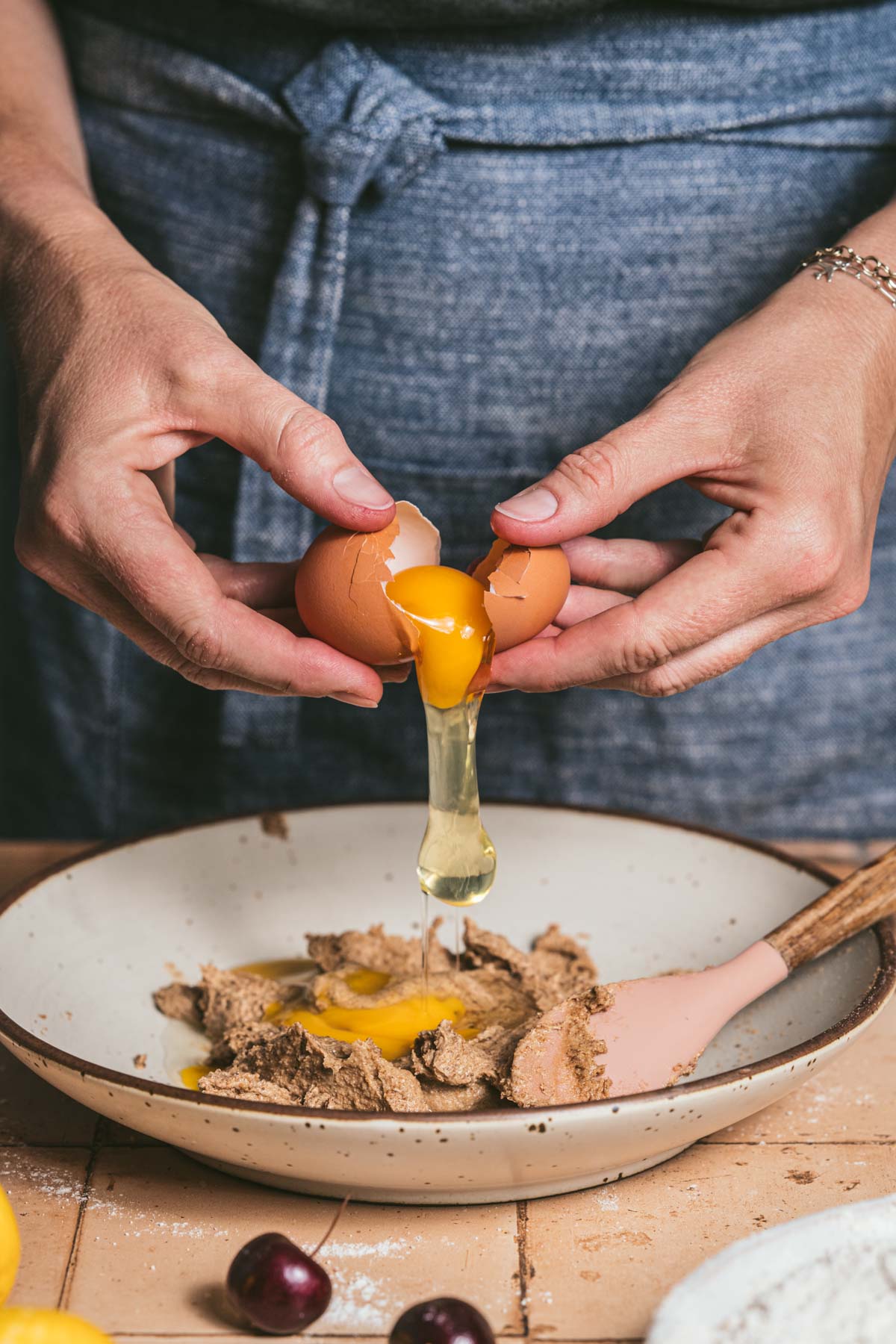 hands in fram holding a cracked egg