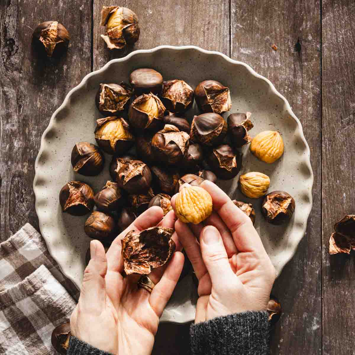 hand holding roasted chestnut