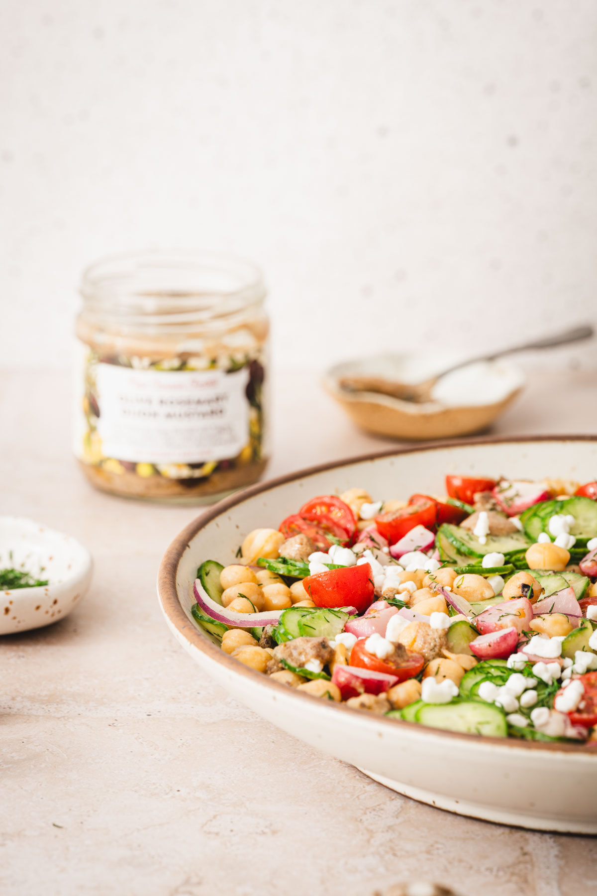 large bowl with salad, jar with mustard, front view