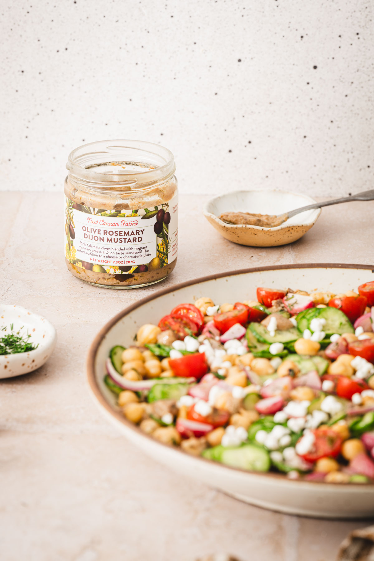 large bowl with salad, jar with mustard, front view