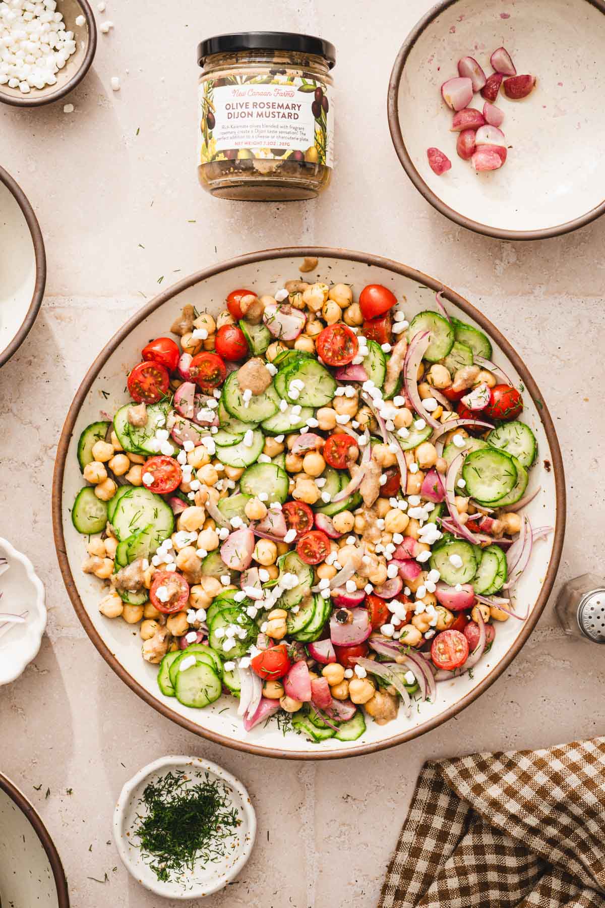 large bowl with the salad, jar with the mustard