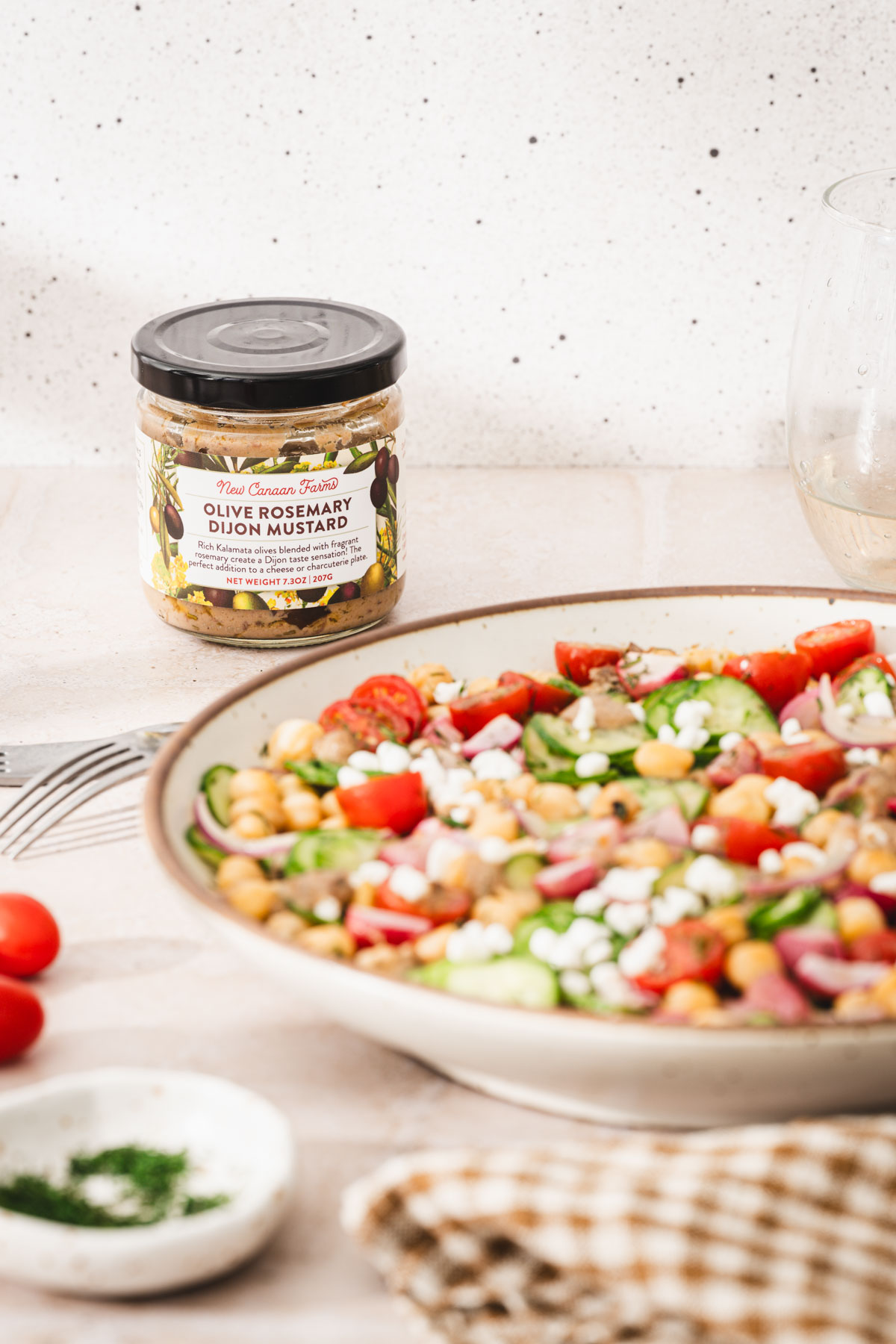 serving bowl with salad, jar with mustard