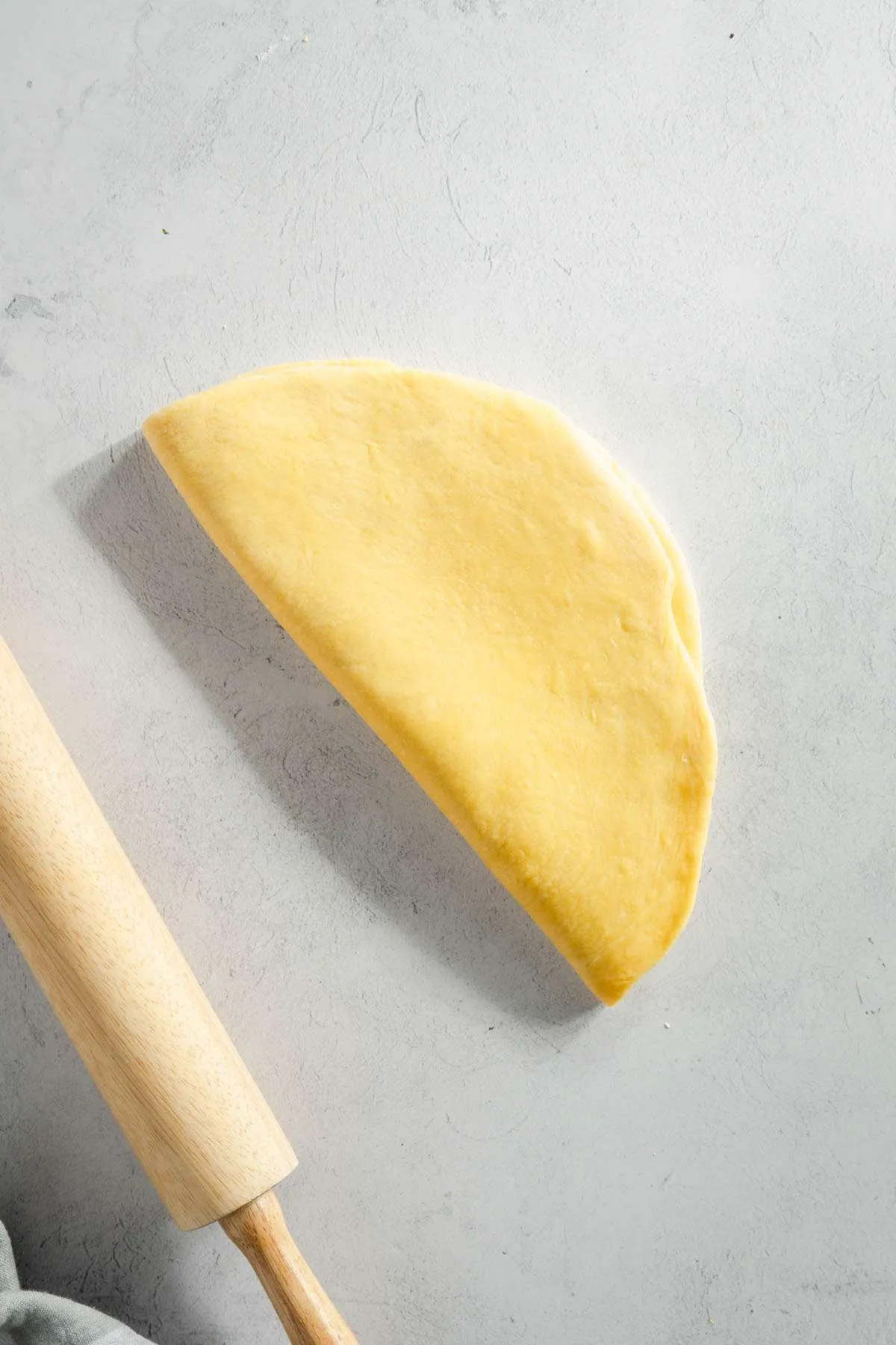 chrusciki dough rolled out and folded in half