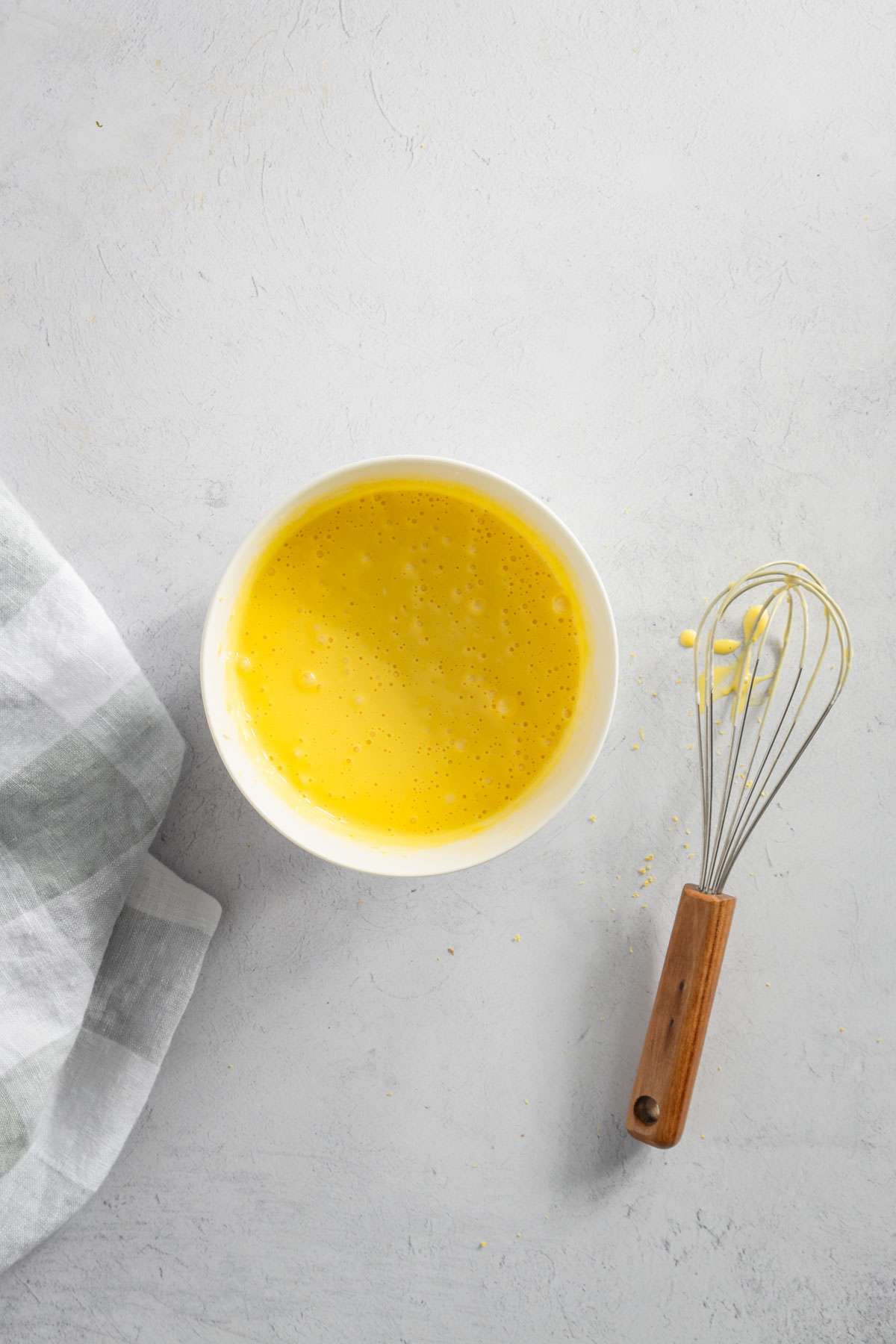 small bowl with egg yolks mixed in with other ingredients