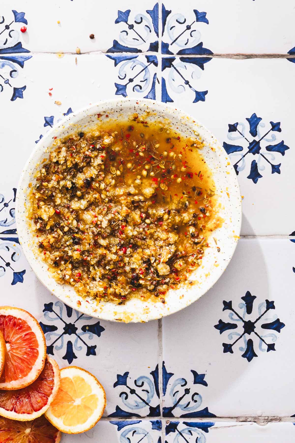 cluse of of a dish with cure, piece of salmon, slices of orange