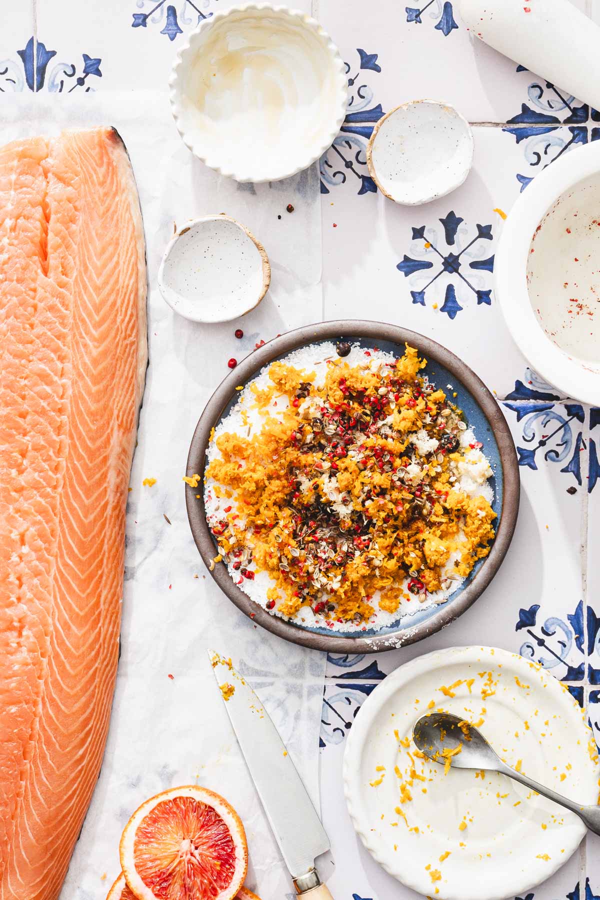 cure prepared on a plate, raw salmon and other containers around