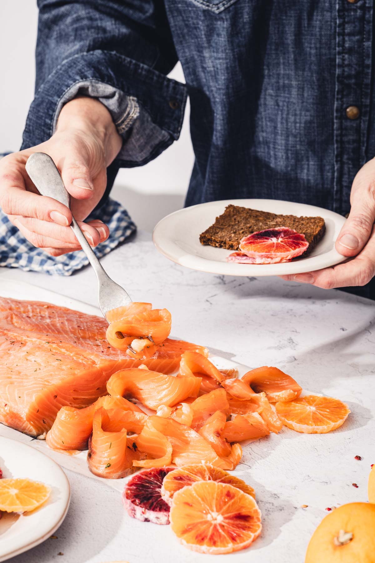 hand in frame holding fork with salmon