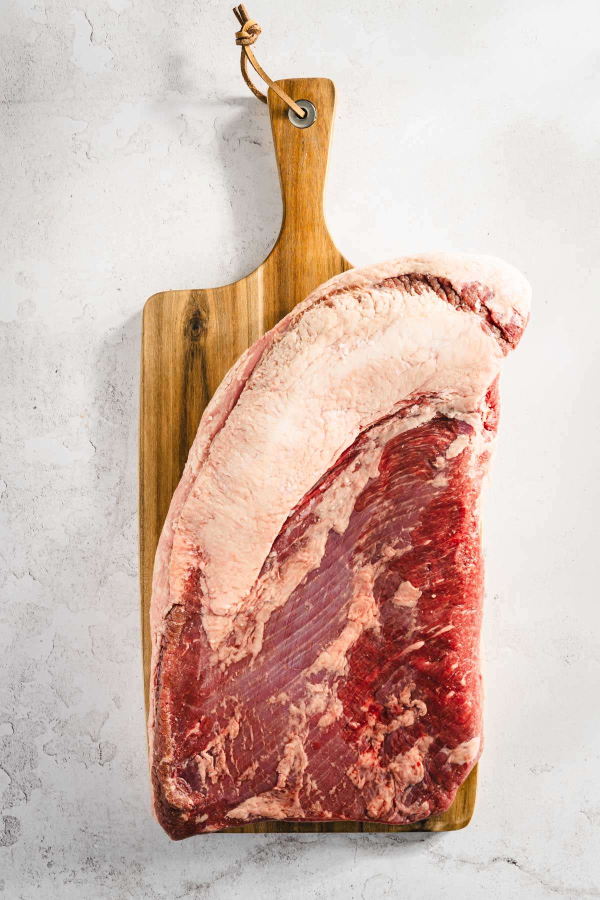 whole raw brisket on the cutting board, before trimming