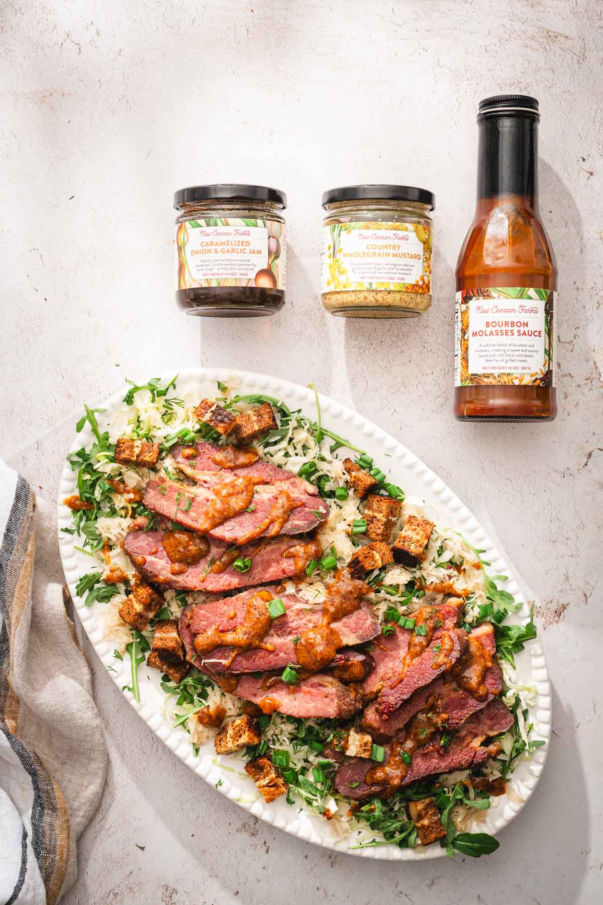 platter with the salad, two jars and a bottle with the products