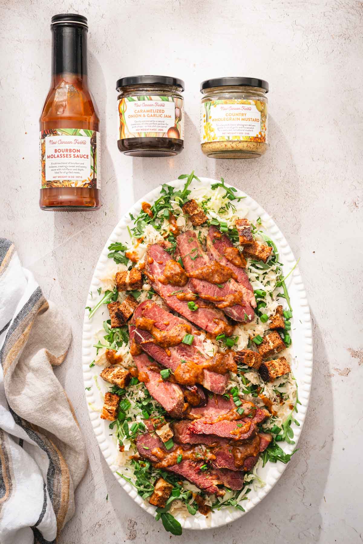 platter with the salad, two jars and a bottle with the products