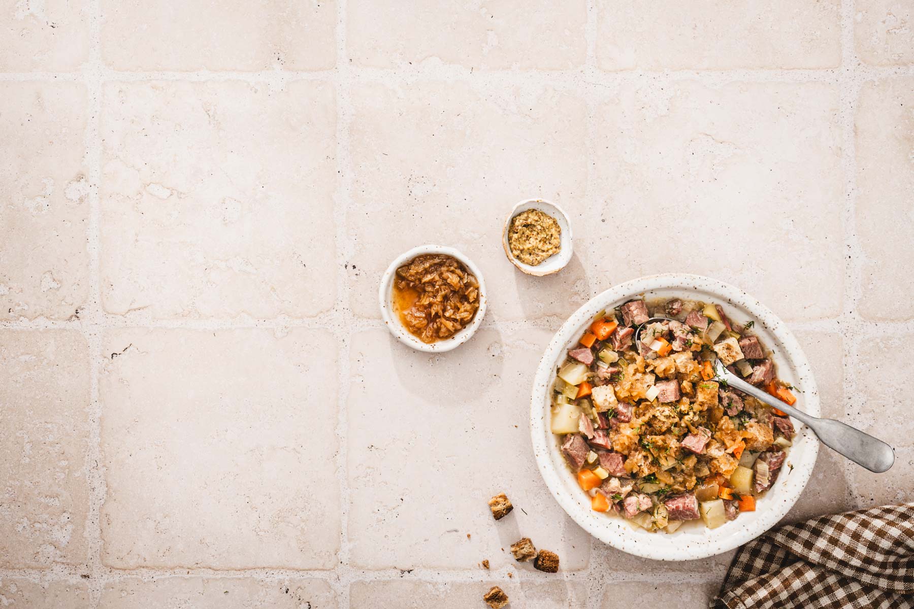 bowl with soup, two dishes one with mustard, one with kraut