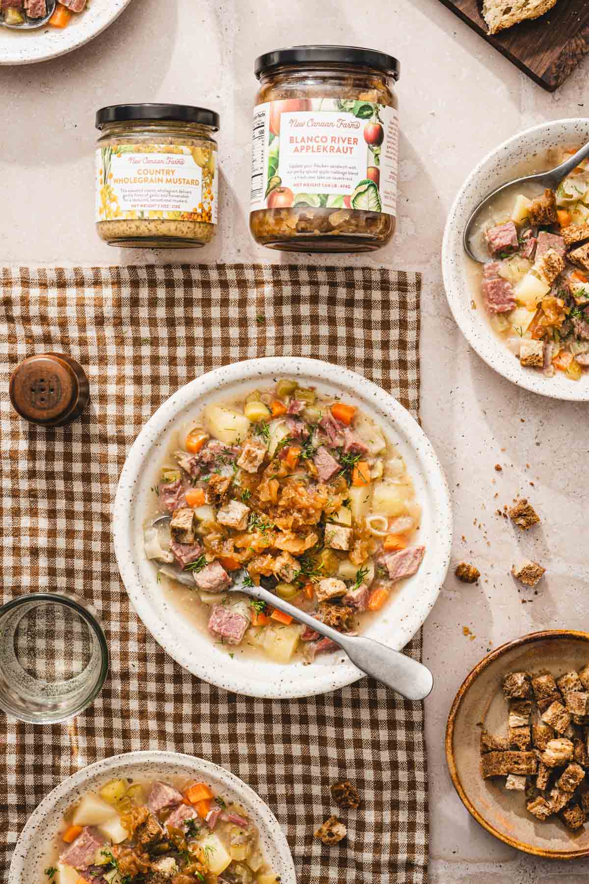soup in a serving bowls, jars with mustard and kraut