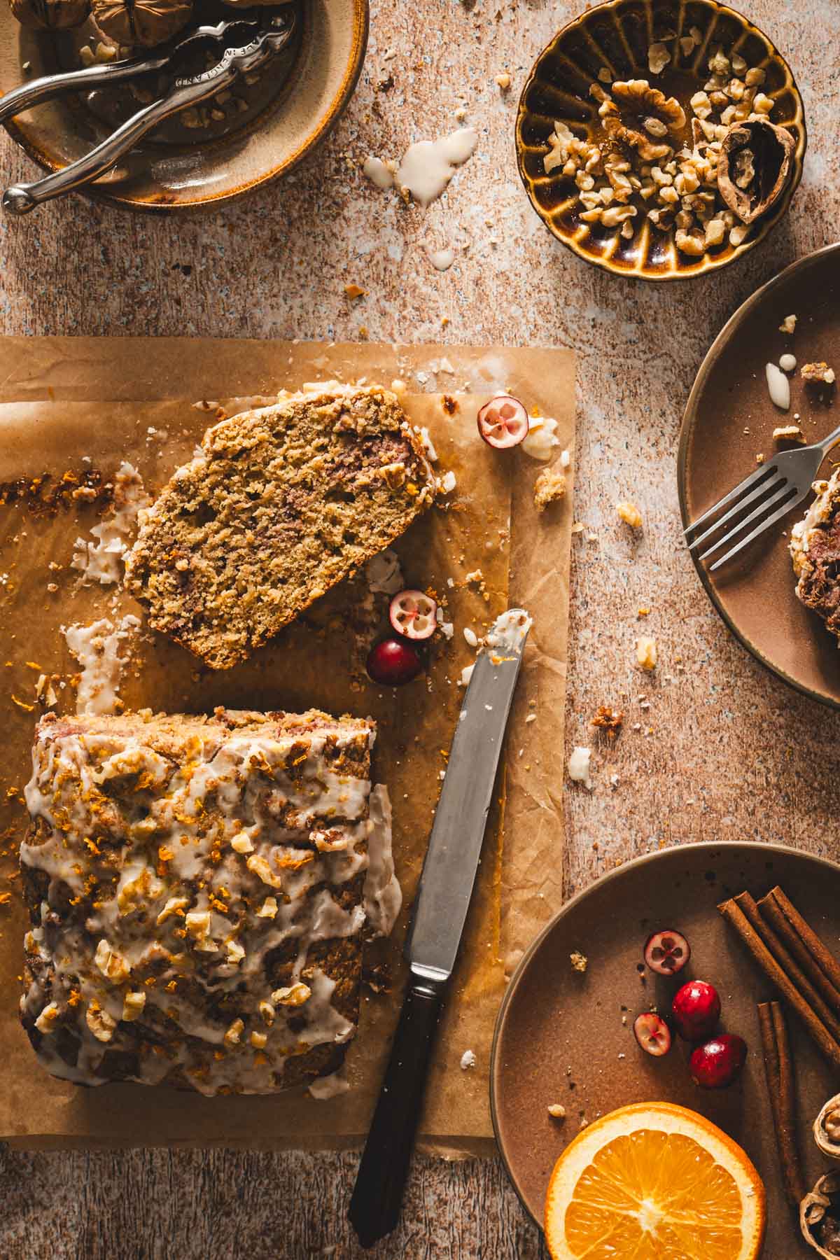 cranberry loaf on parchment paper, plates with spices