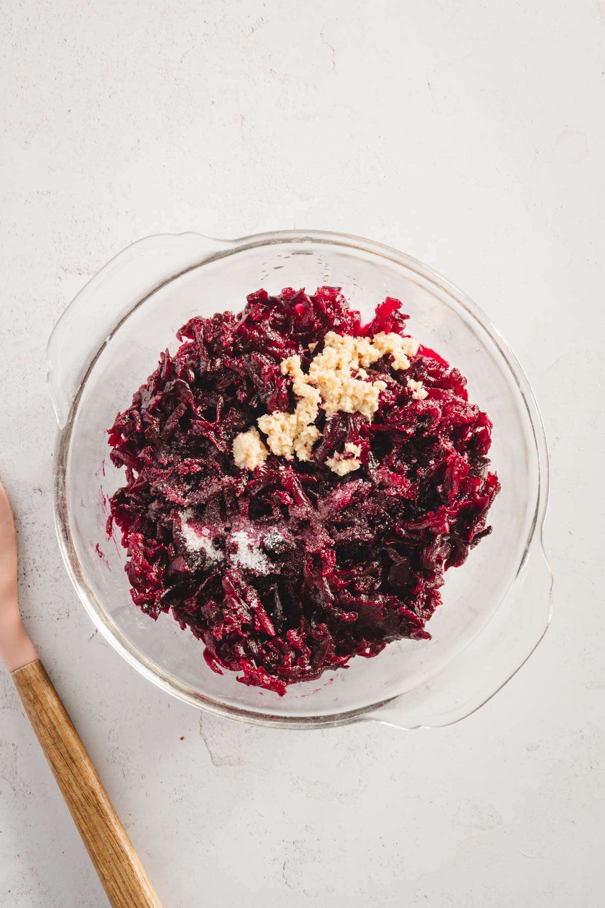 shredded beets and other ingredients in a glass bowl