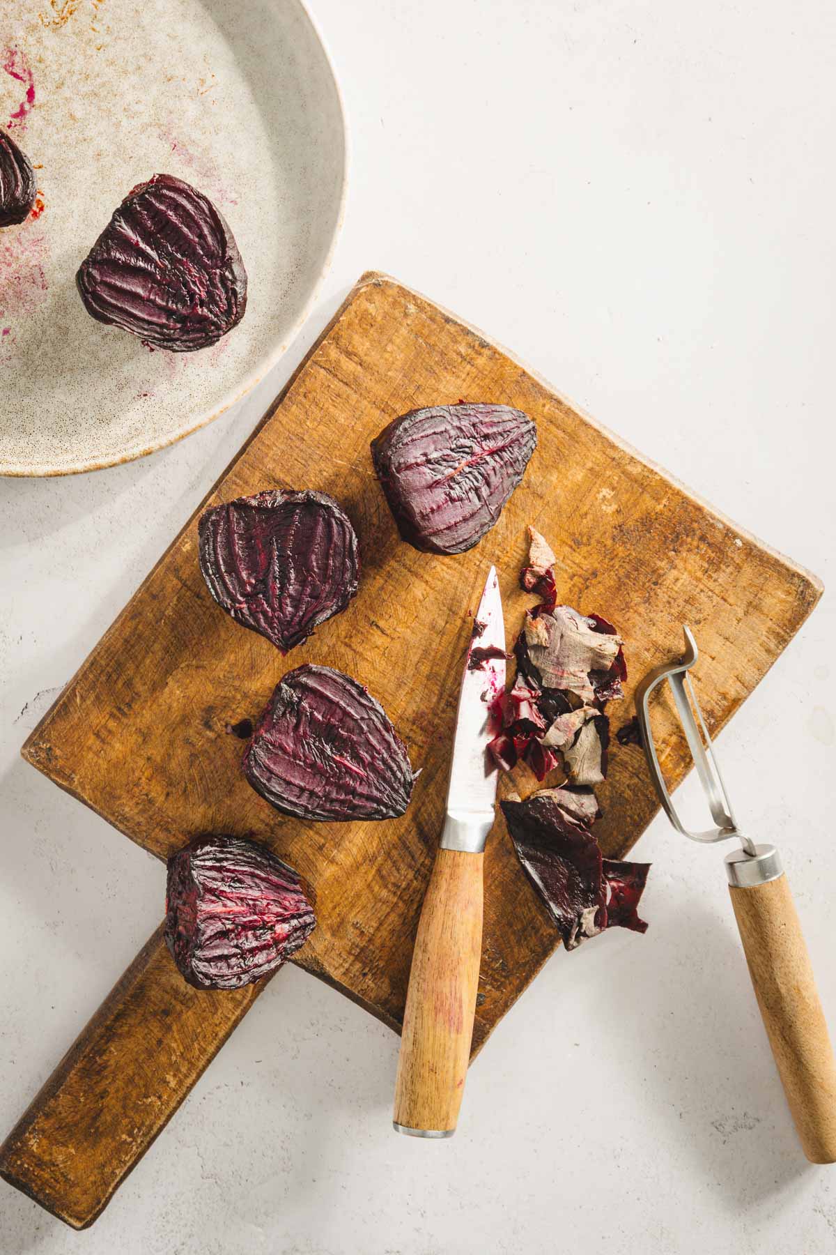 roasted beets on a cutting board, some peeled