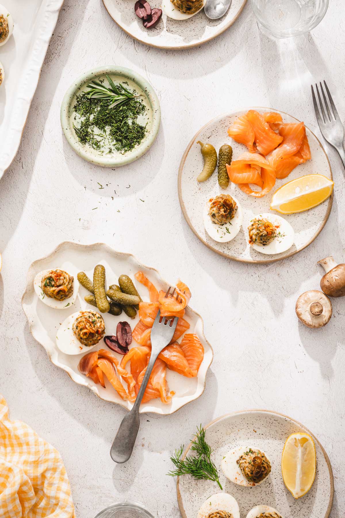 various plates with cured salmon and deviled eggs