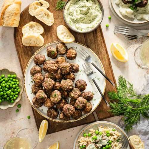 close up of dill meatballs plate, slices of bread, little forks