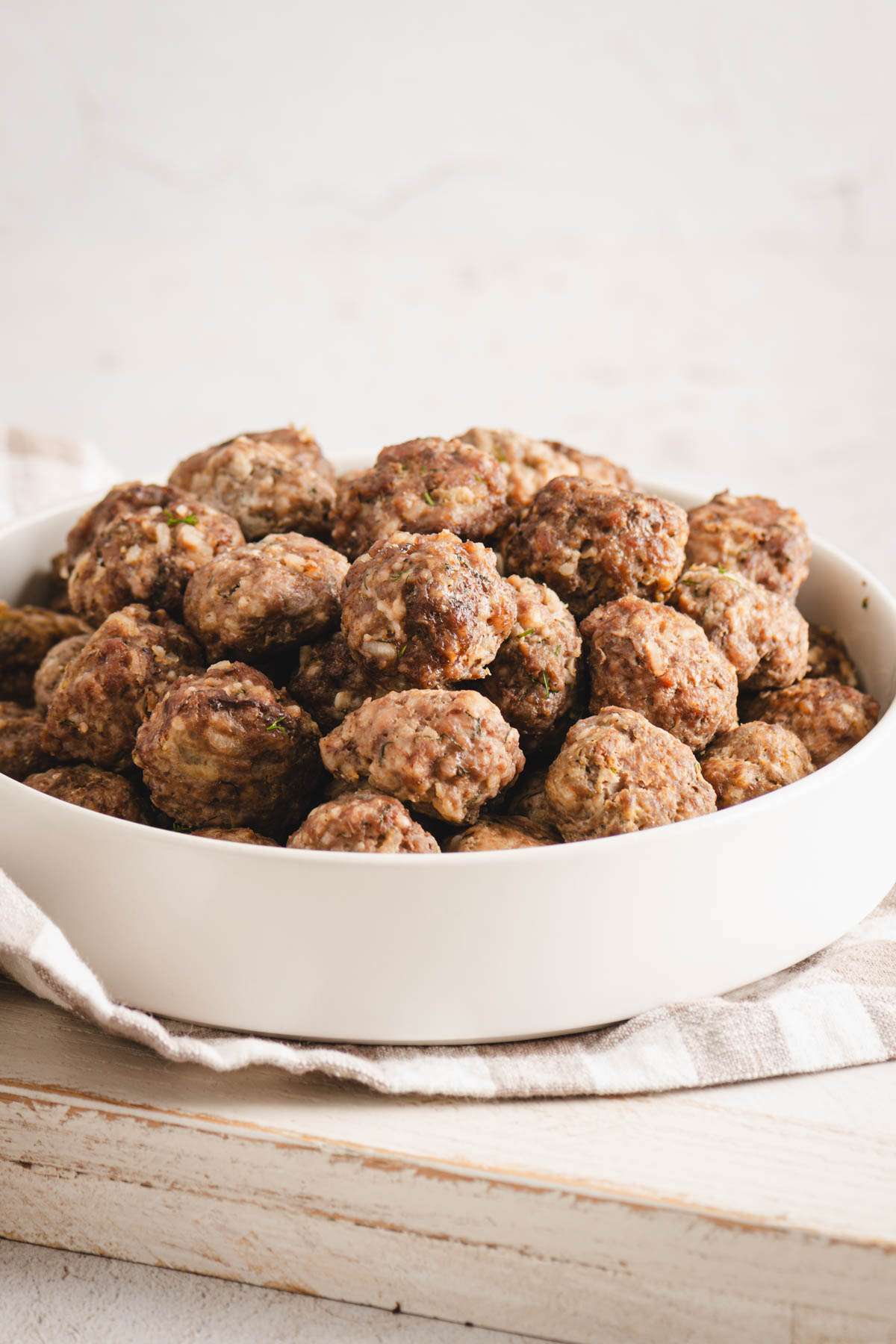 plane meatballs in a white bowl, front view