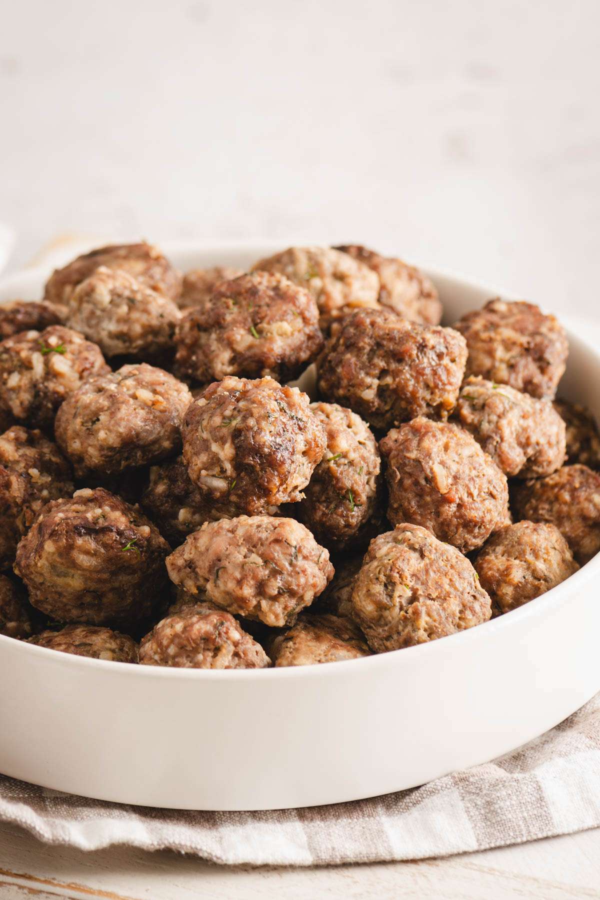 plane meatballs in a white bowl, front view, close up