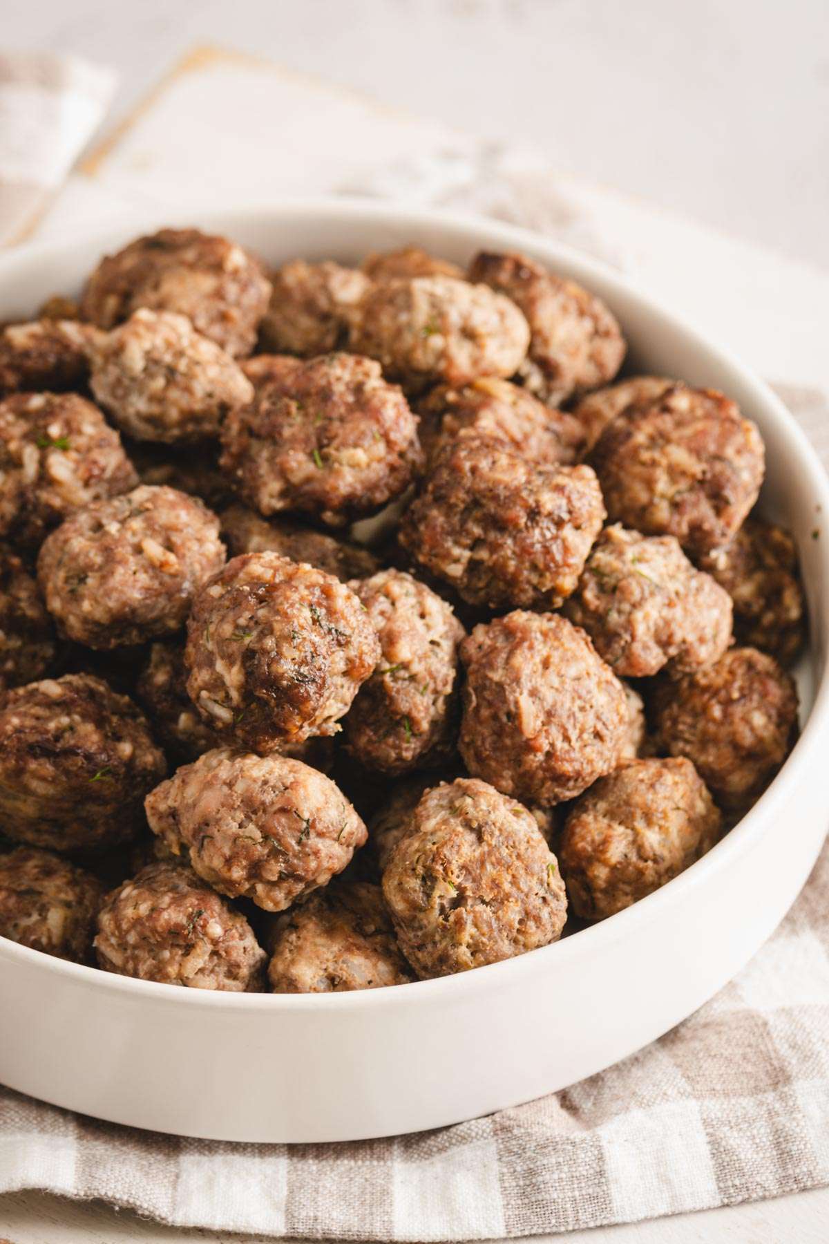 plane meatballs in a white bowl, front view, close up