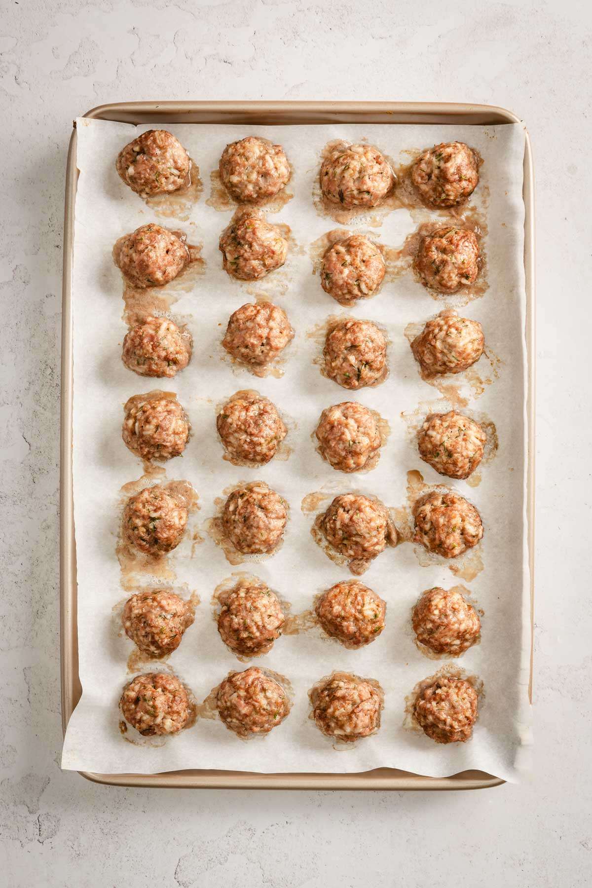 baked meatballs on a baking sheet