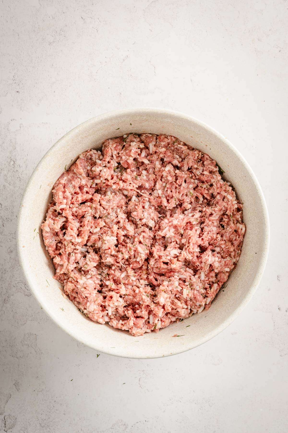 bowl with meatball ingredients mixed together