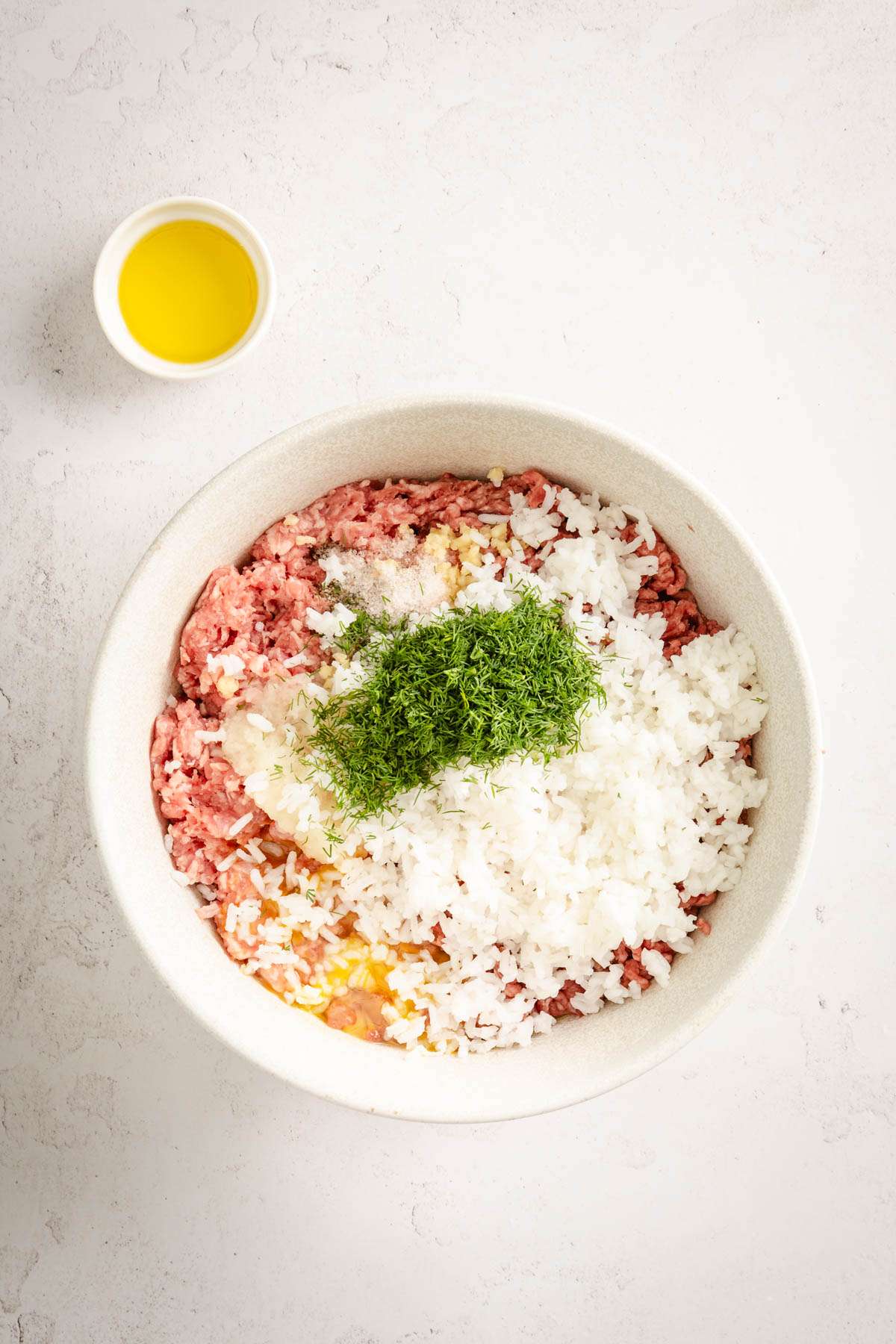 bowl with all the ingredient to make meatballs