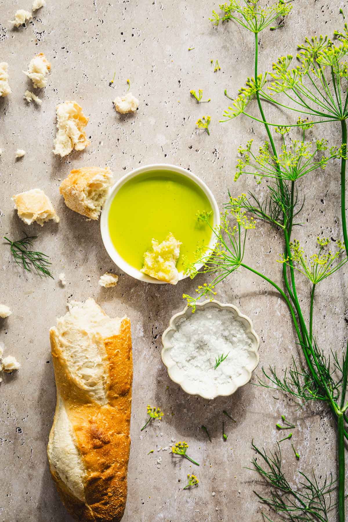 dish with dill oil, branches of fresh dill, bread crumbs, baguette, dish with salt