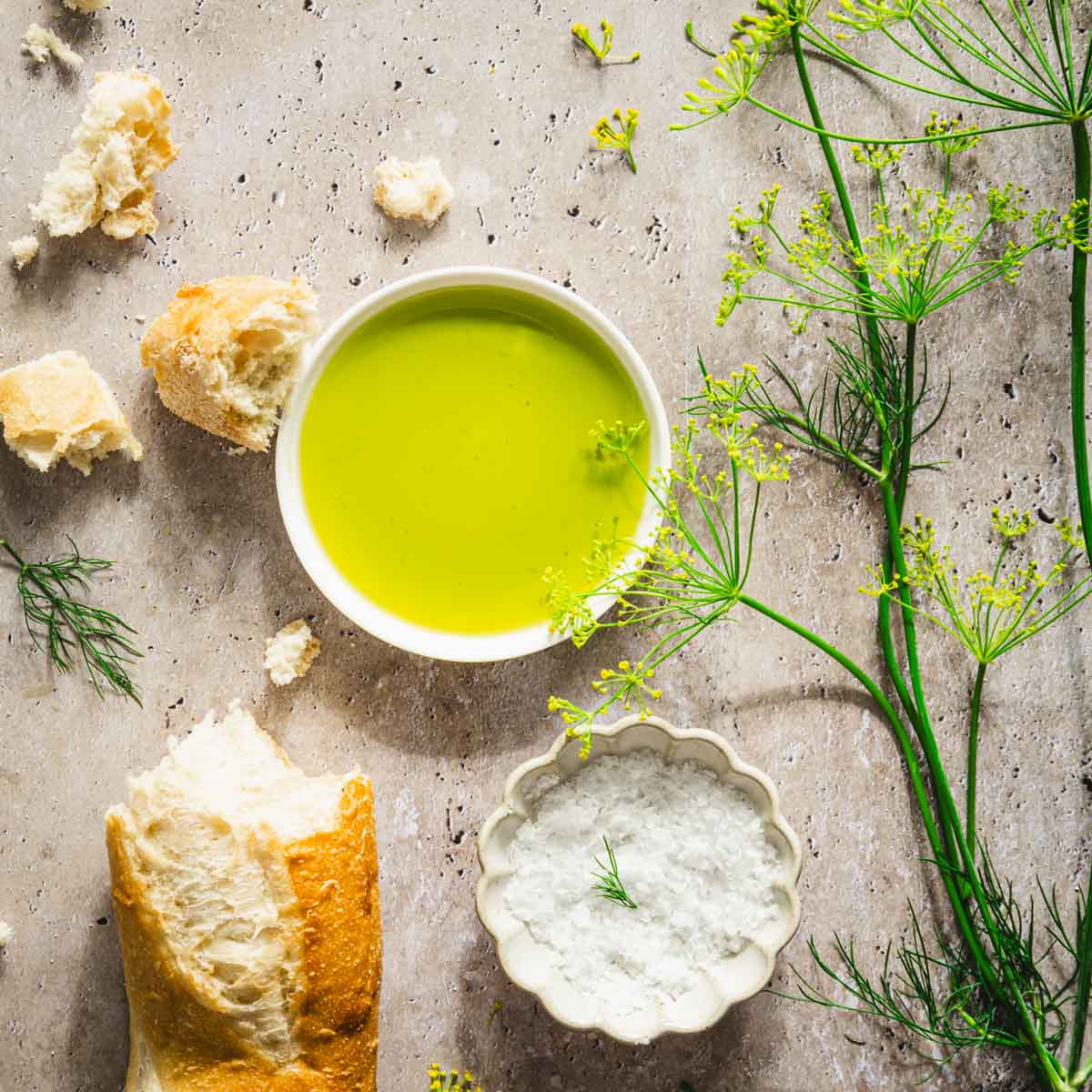 dish with dill oil, branches of fresh dill, bread crumbs, baguette