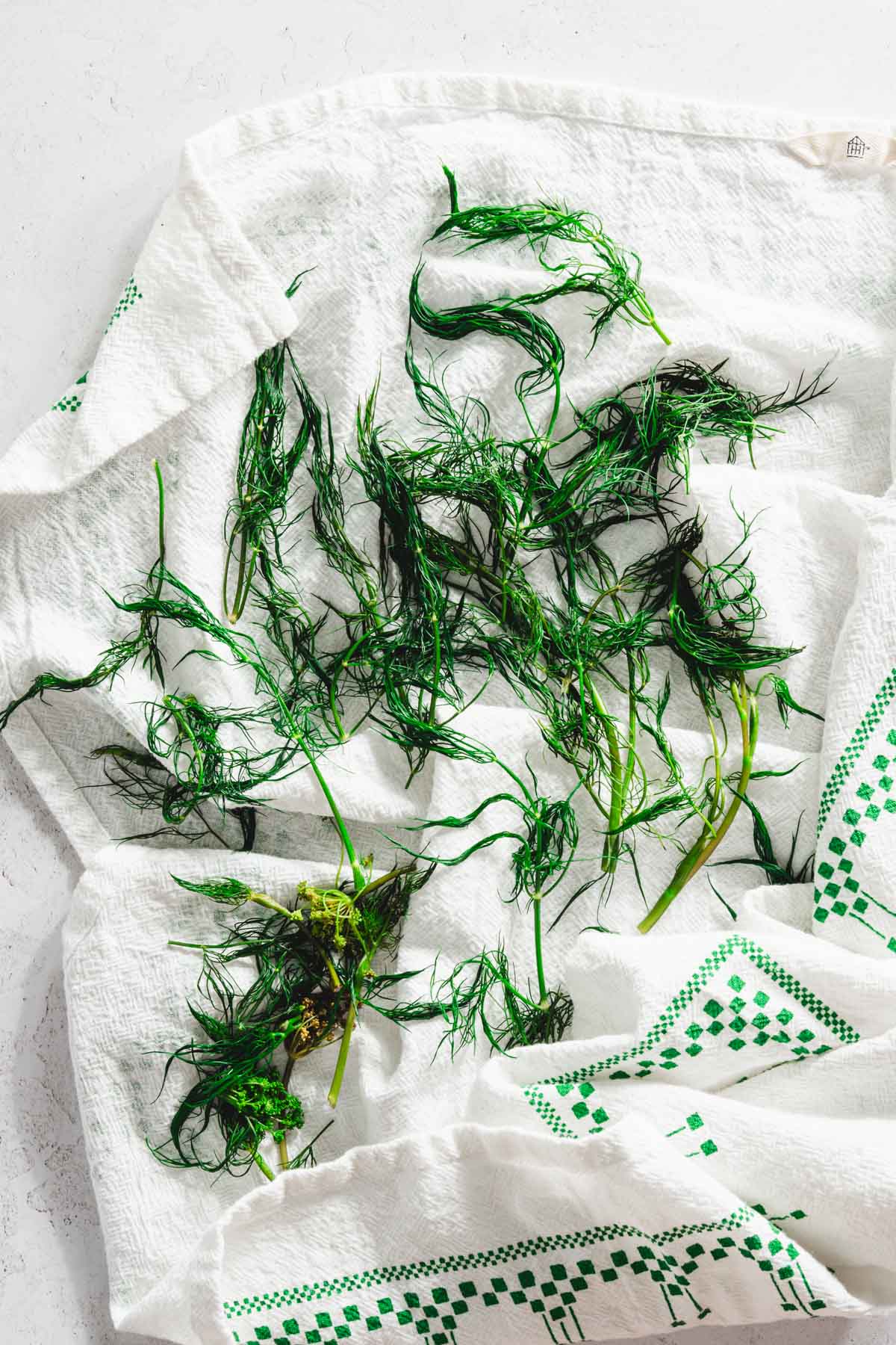 blanched dill on a kitchen towel