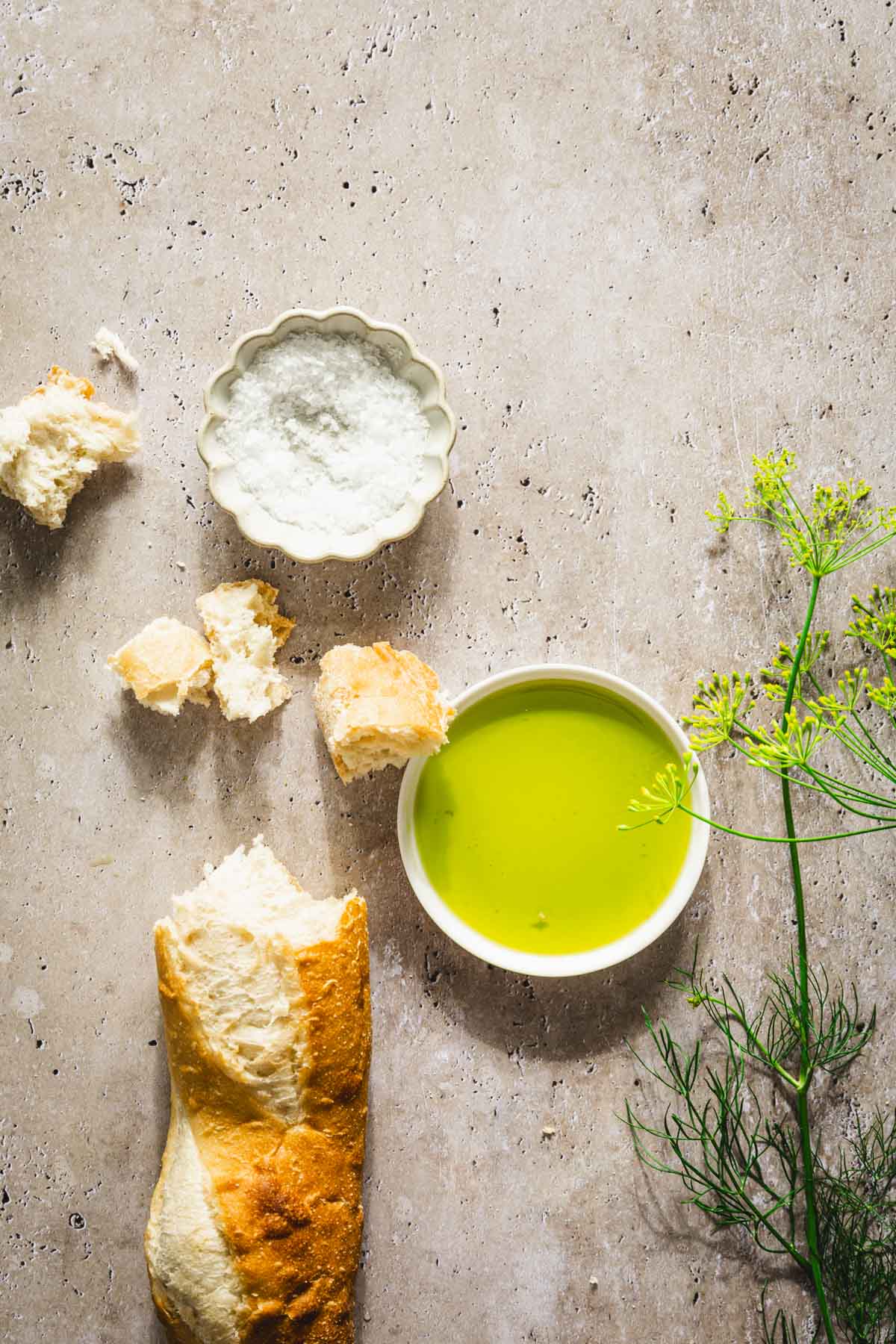 dish with dill oil, branches of fresh dill, bread crumbs, baguette, dish with salt