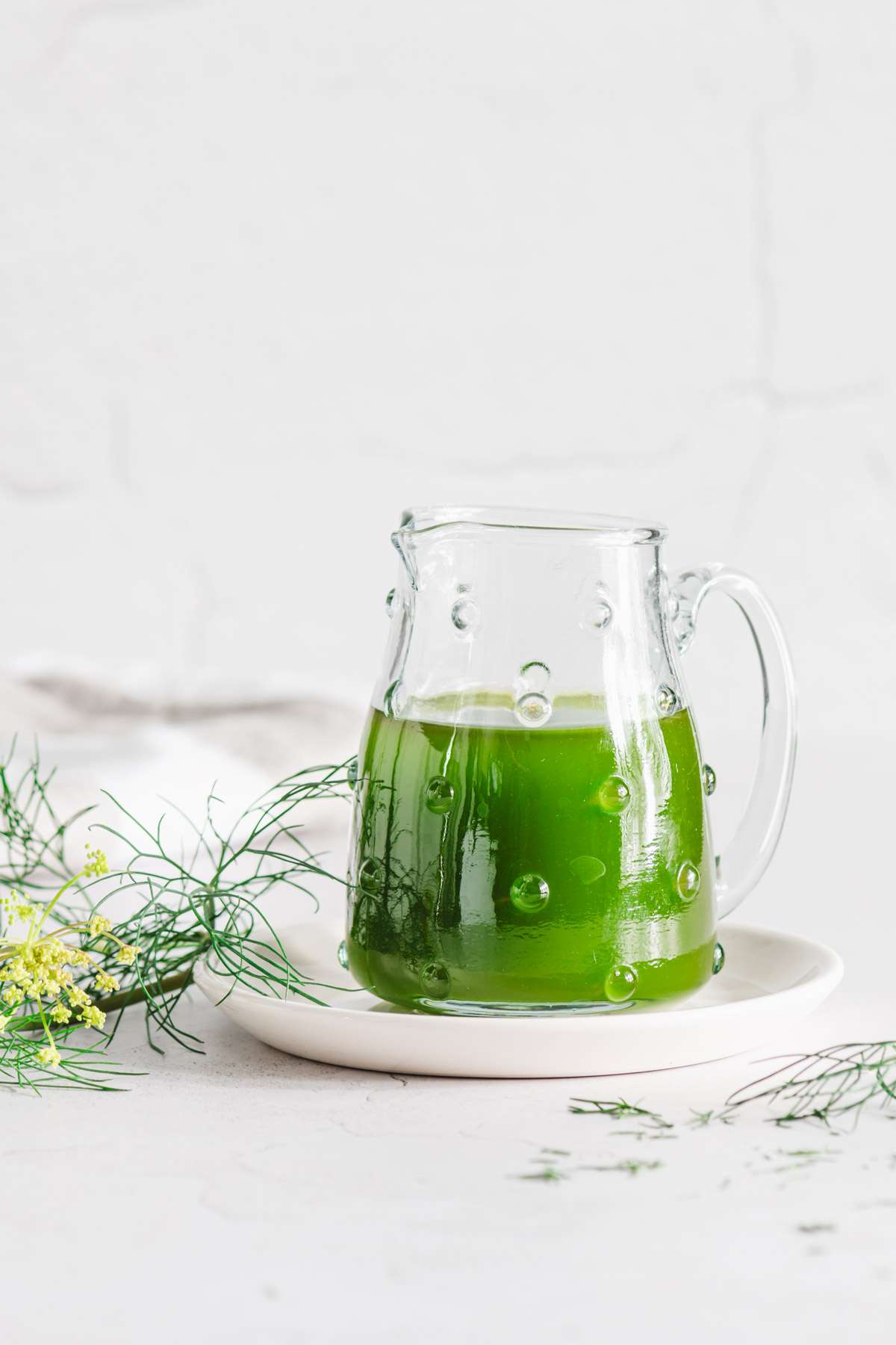 dill oil in a glass dish, front view