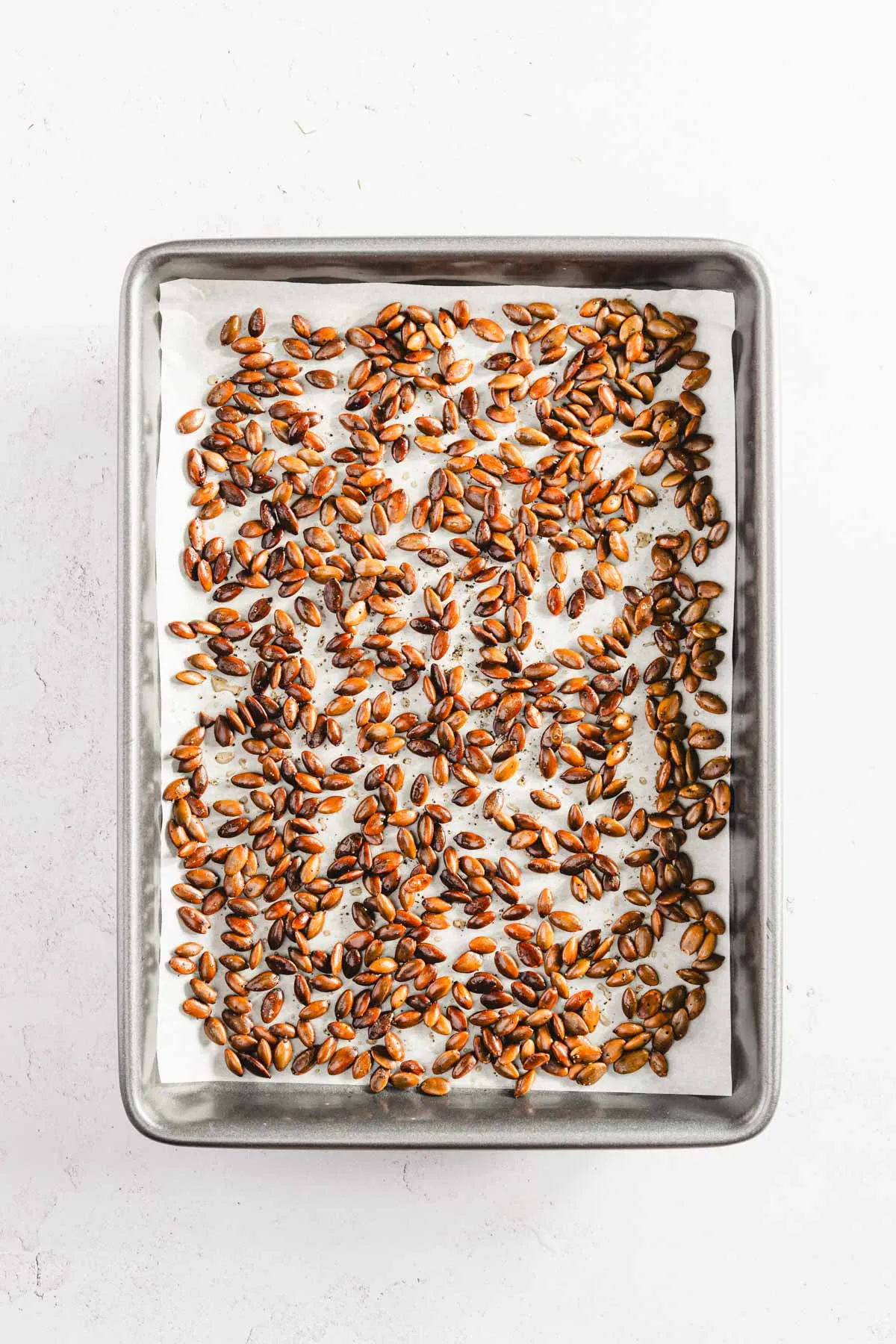 roasted pumpkin seeds on a baking sheet