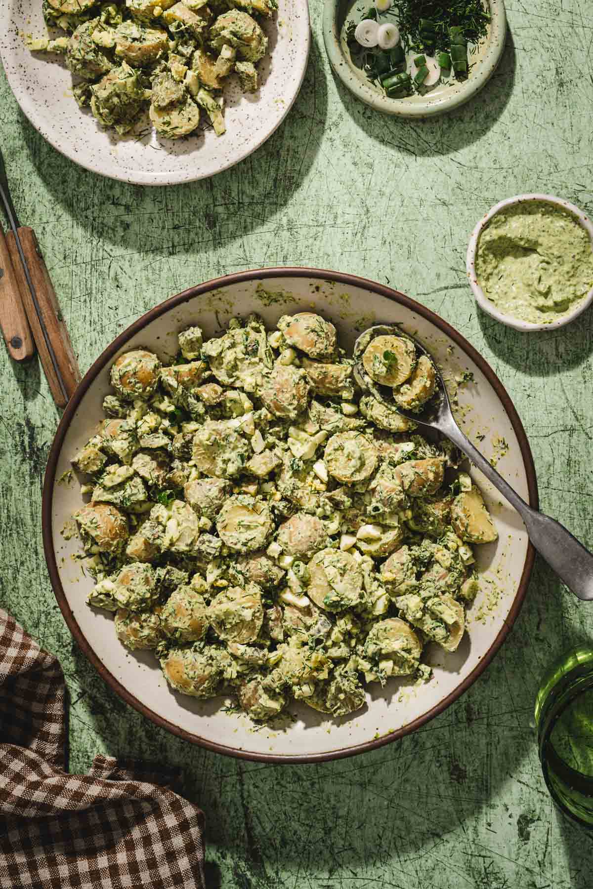 top view of a serving bowl with dill pesto potato salad