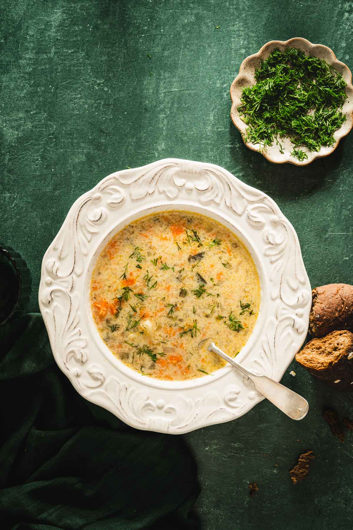 dill pickle soup in a serving bowl, green background