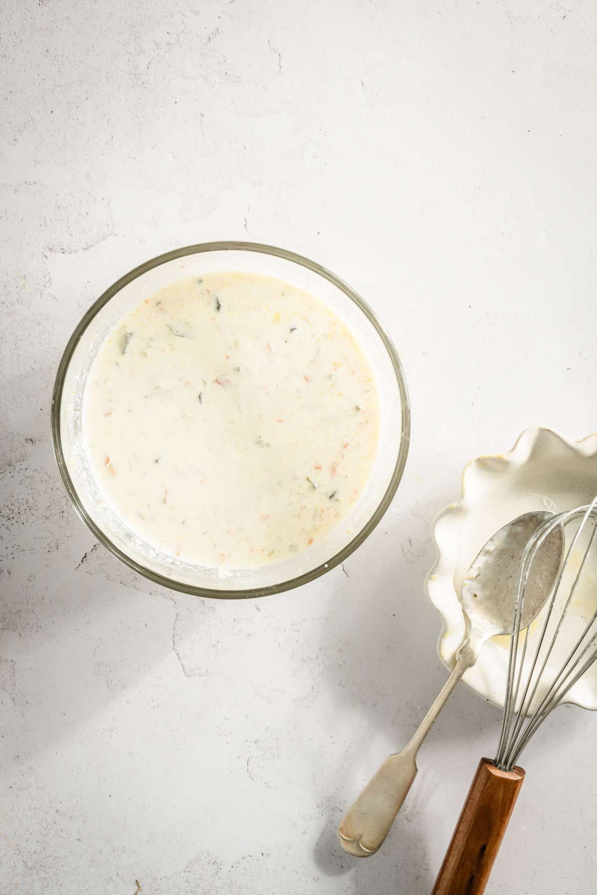 glass bowl with the soup mixed with sour cream