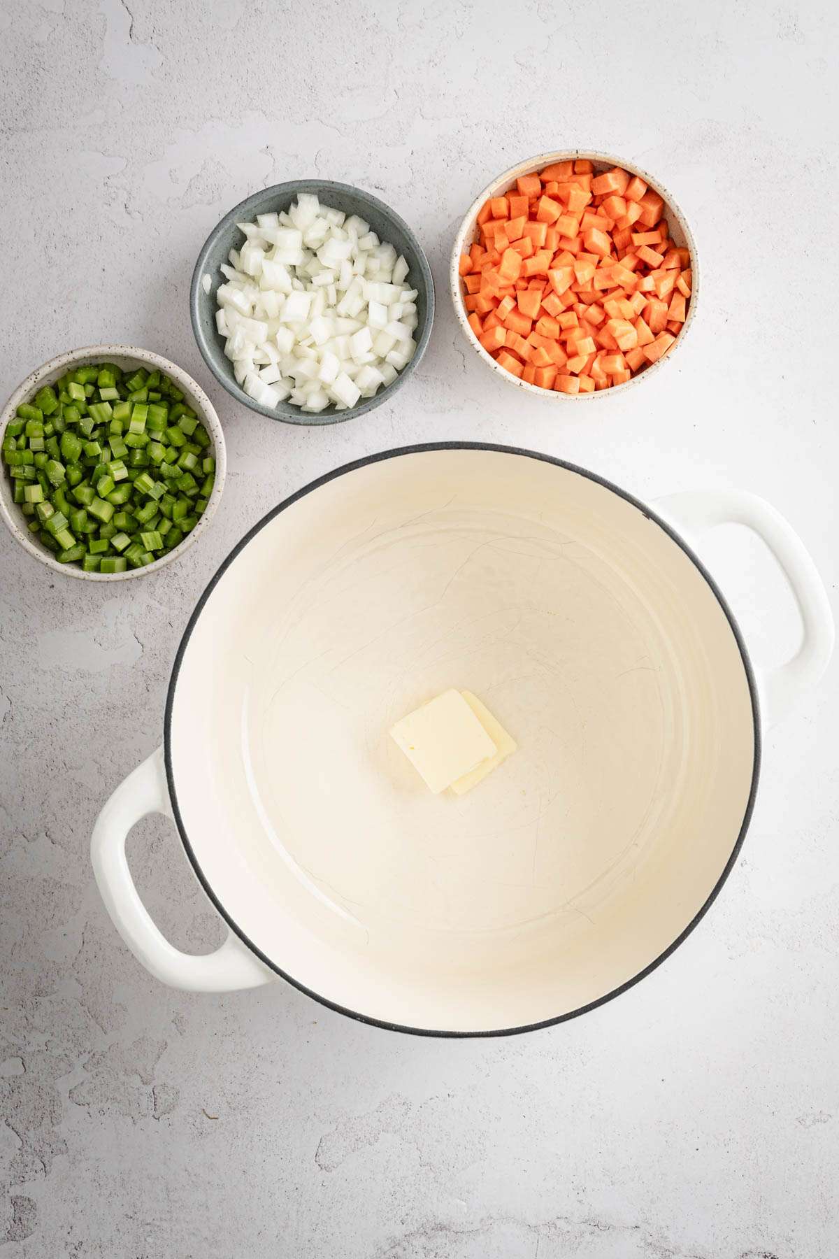 large stock pot, small bowls with chopped celery, onion and carrots