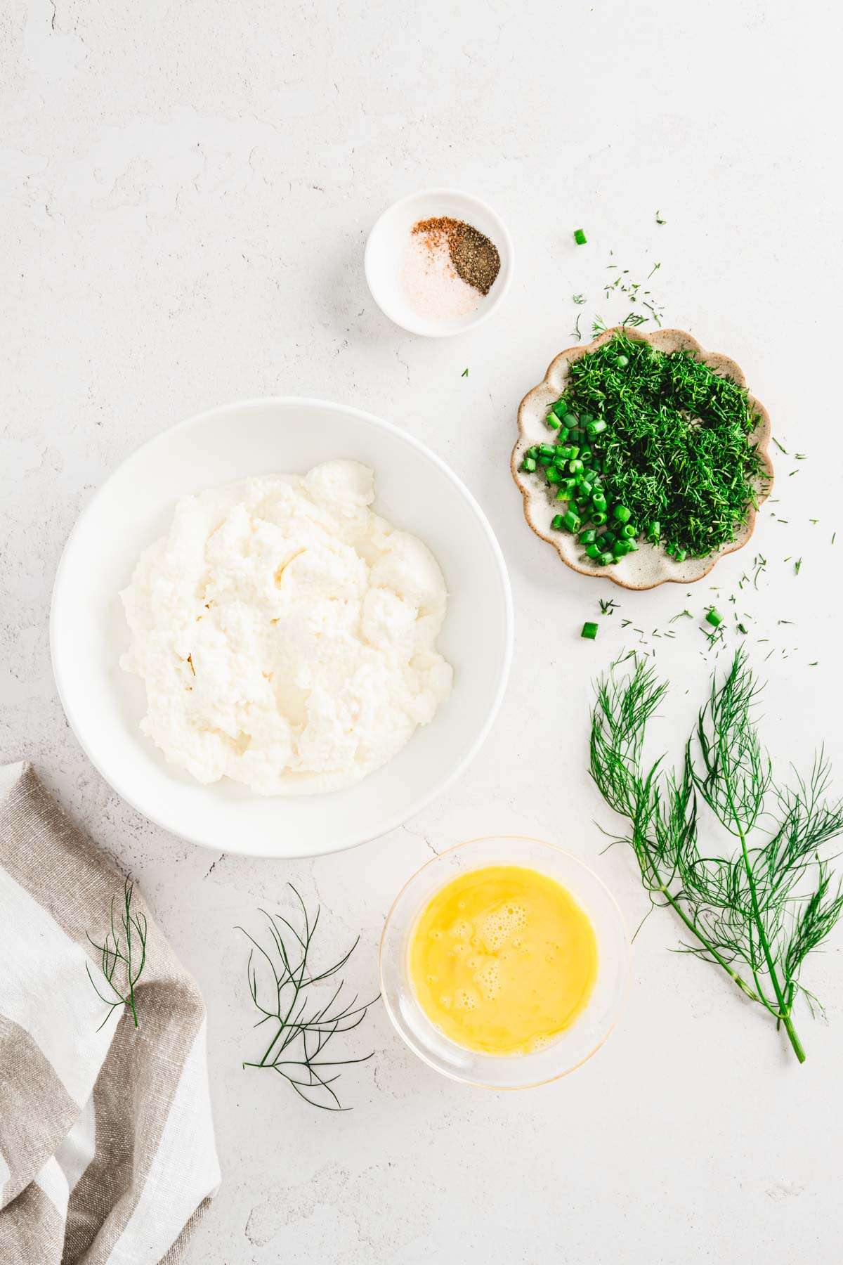 ricotta cheese in a bowl, other ingredients arranged around