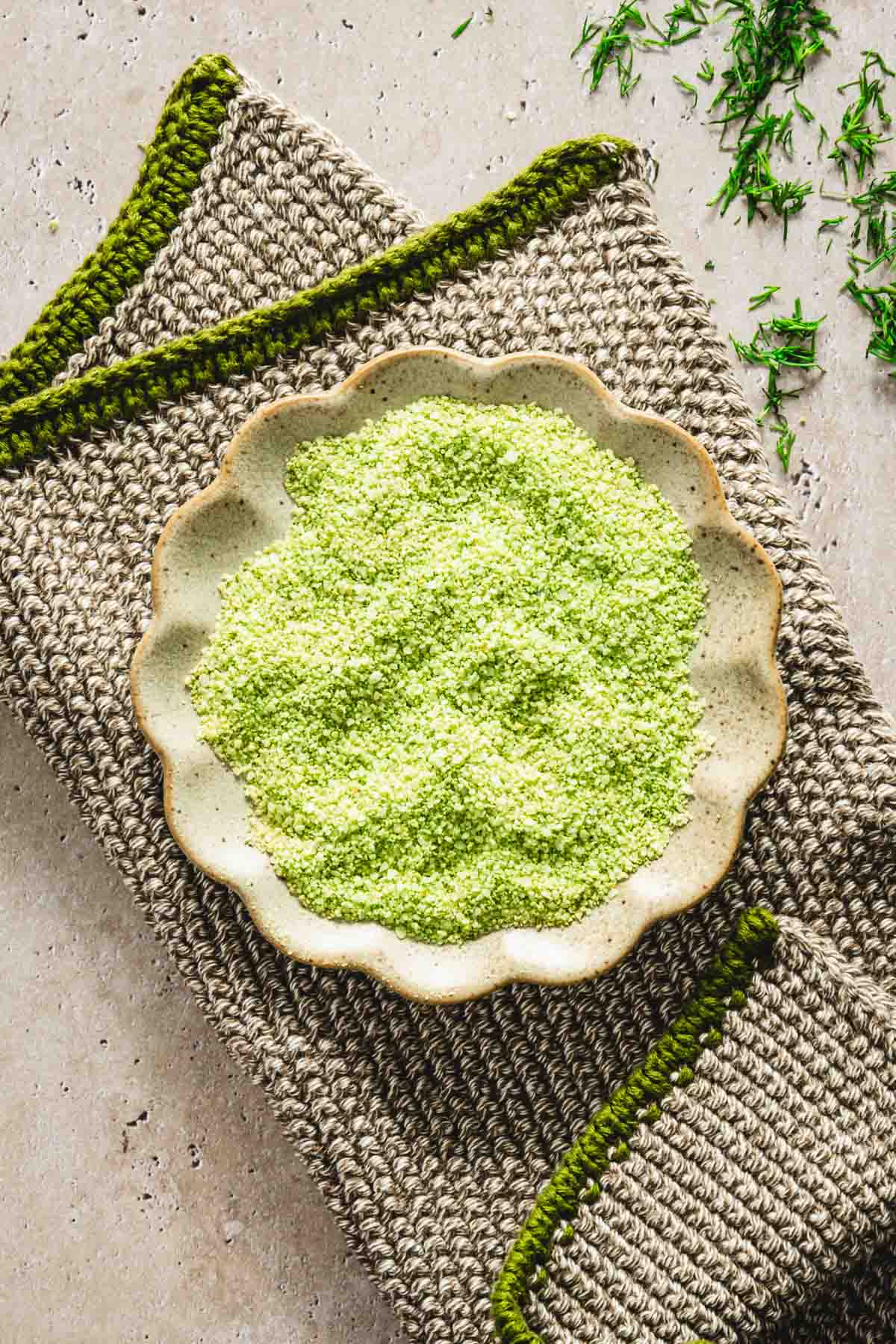 dill salt in a shallow dish placed on a napkin, close up