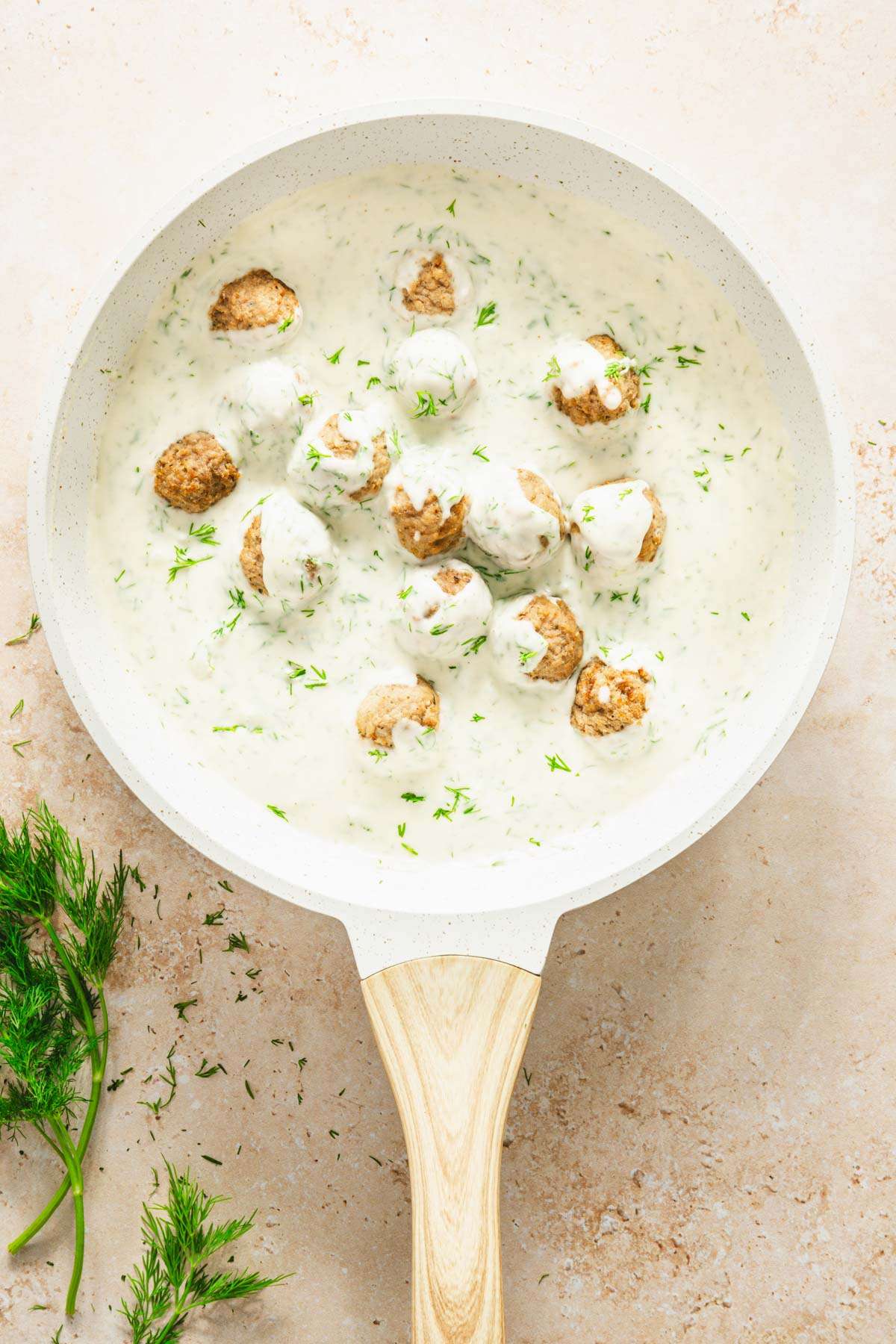 pan with dill sauce and meatballs